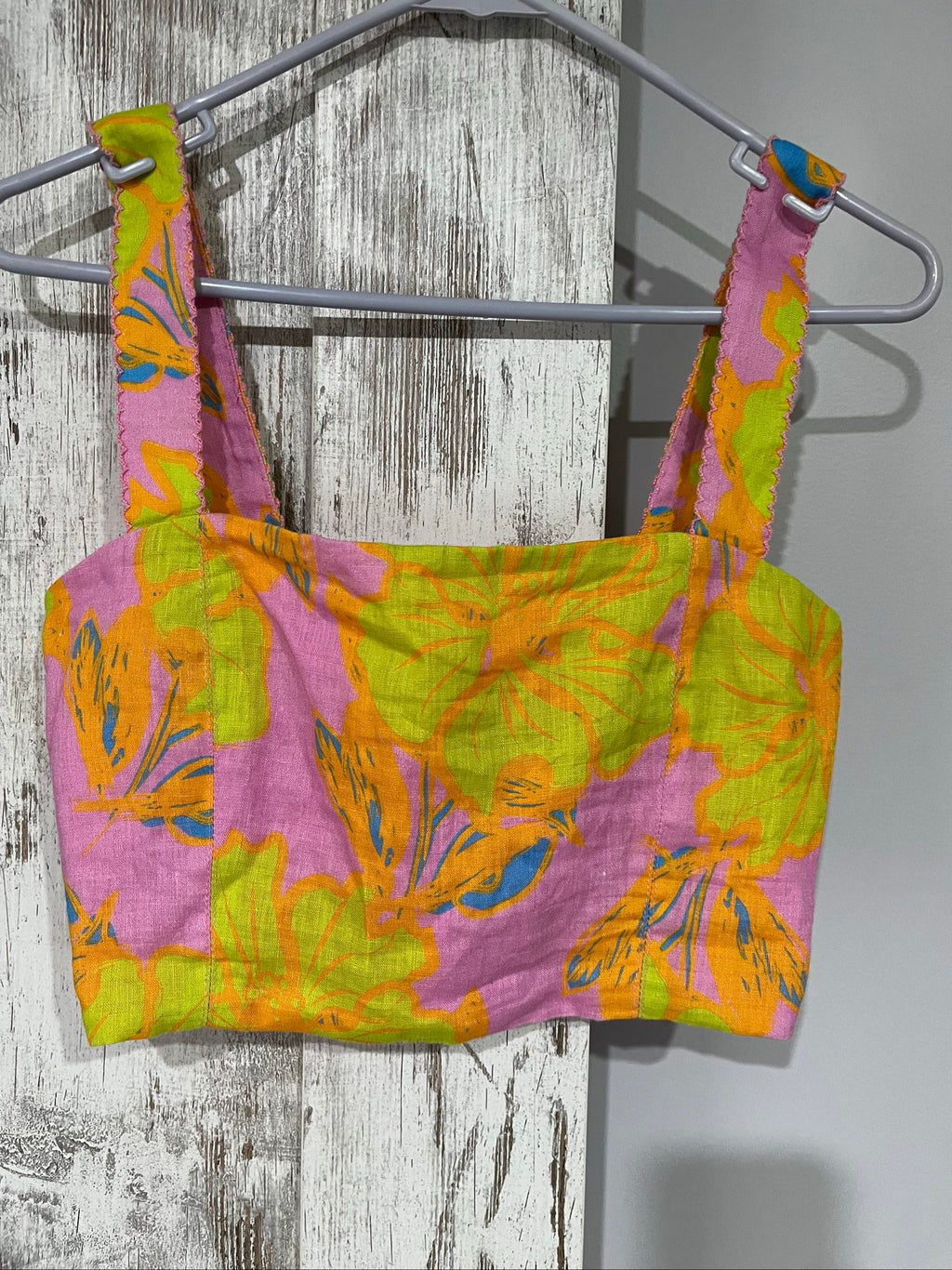 Versify floral crop top in pink, green, and orange, wide straps, smocked back, linen material.