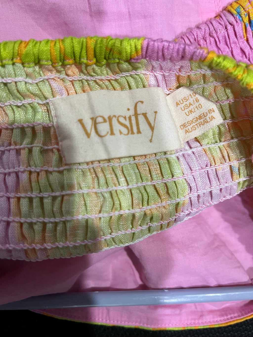 Versify floral crop top in pink, green, and orange, wide straps, smocked back, linen material.