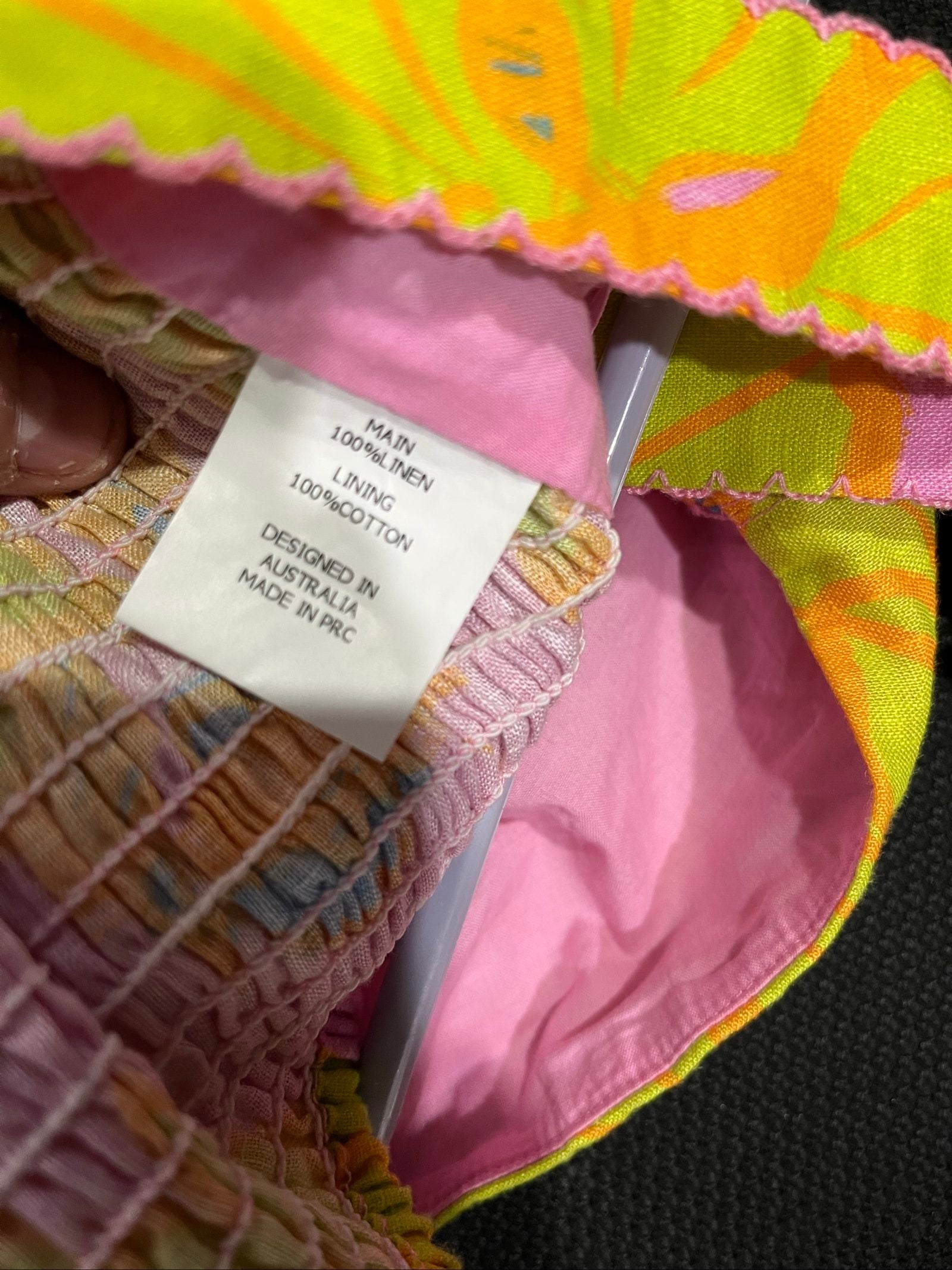 Versify floral crop top in pink, green, and orange, wide straps, smocked back, linen material.