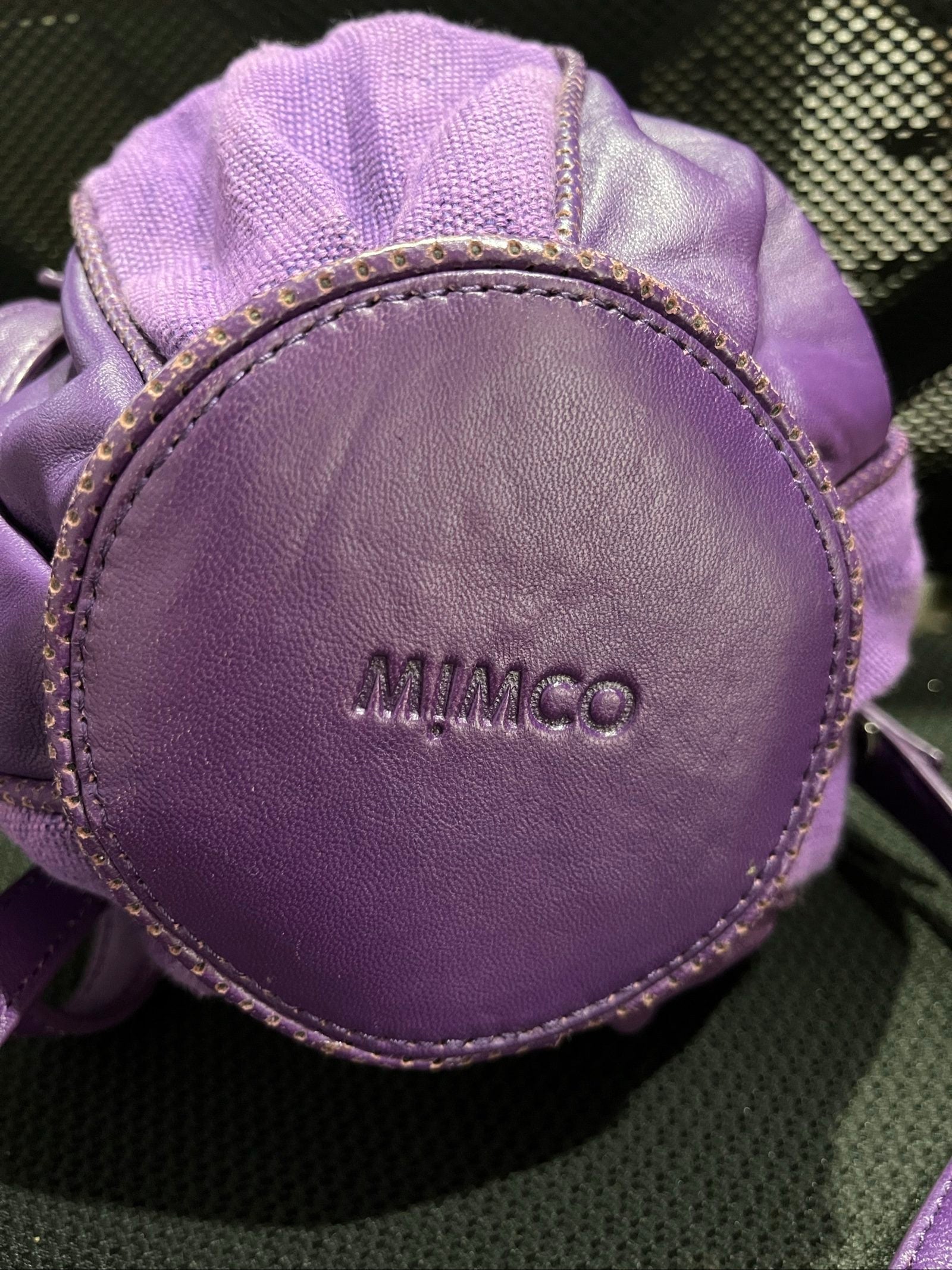 MIMCO purple leather and canvas drawstring crossbody bag with embossed logo and large ring pull.