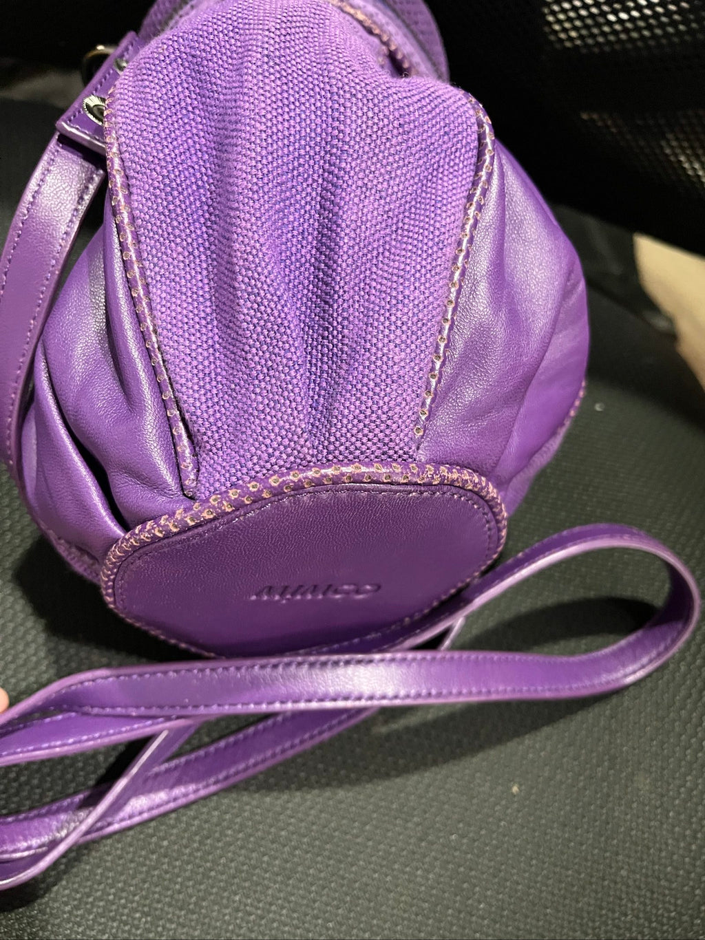 MIMCO purple leather and canvas drawstring crossbody bag with embossed logo and large ring pull.