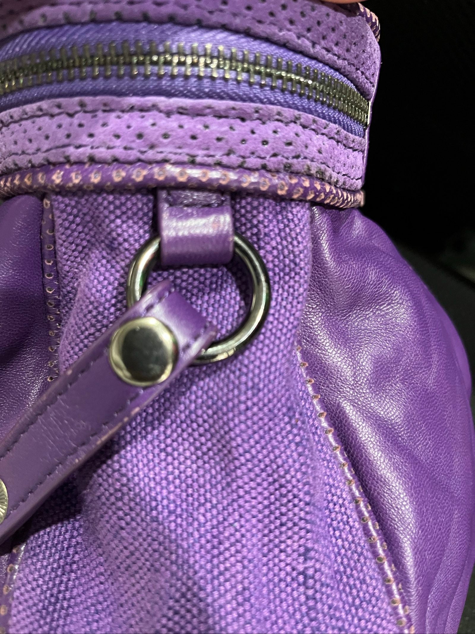 MIMCO purple leather and canvas drawstring crossbody bag with embossed logo and large ring pull.