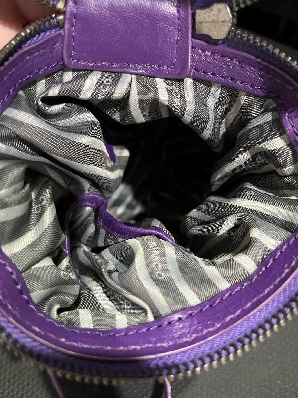 MIMCO purple leather and canvas drawstring crossbody bag with embossed logo and large ring pull.