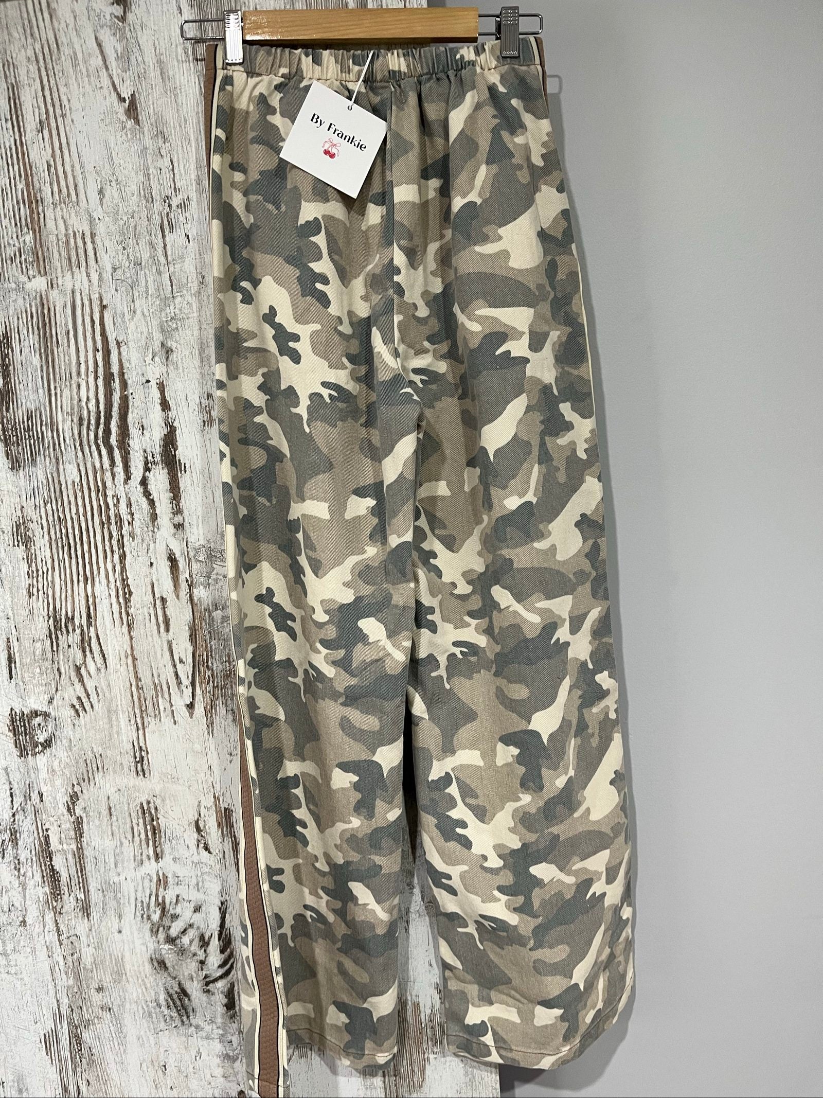 By Frankie beige and grey camo print wide-leg trousers with brown side stripes.
