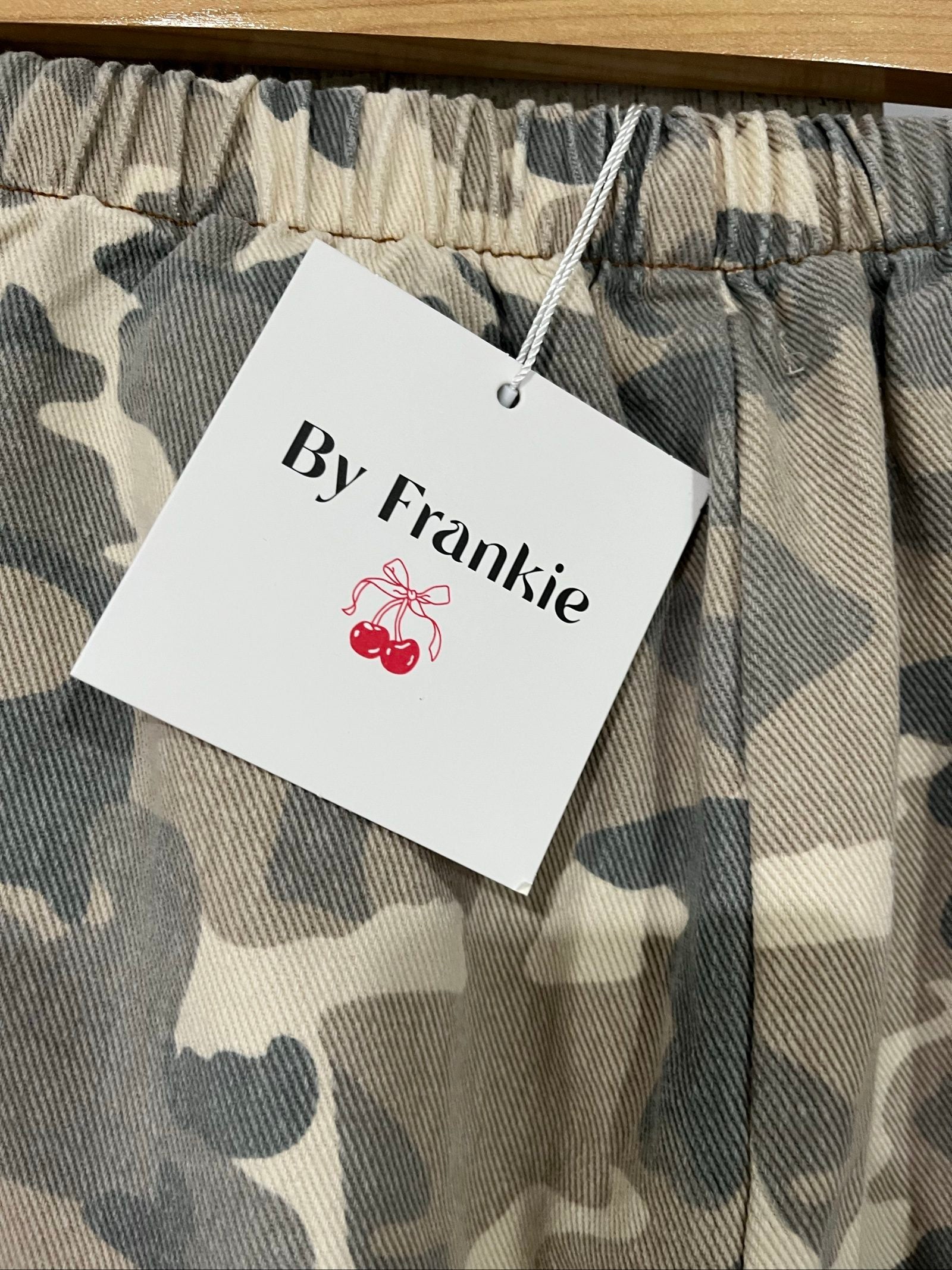 By Frankie beige and grey camo print wide-leg trousers with brown side stripes.