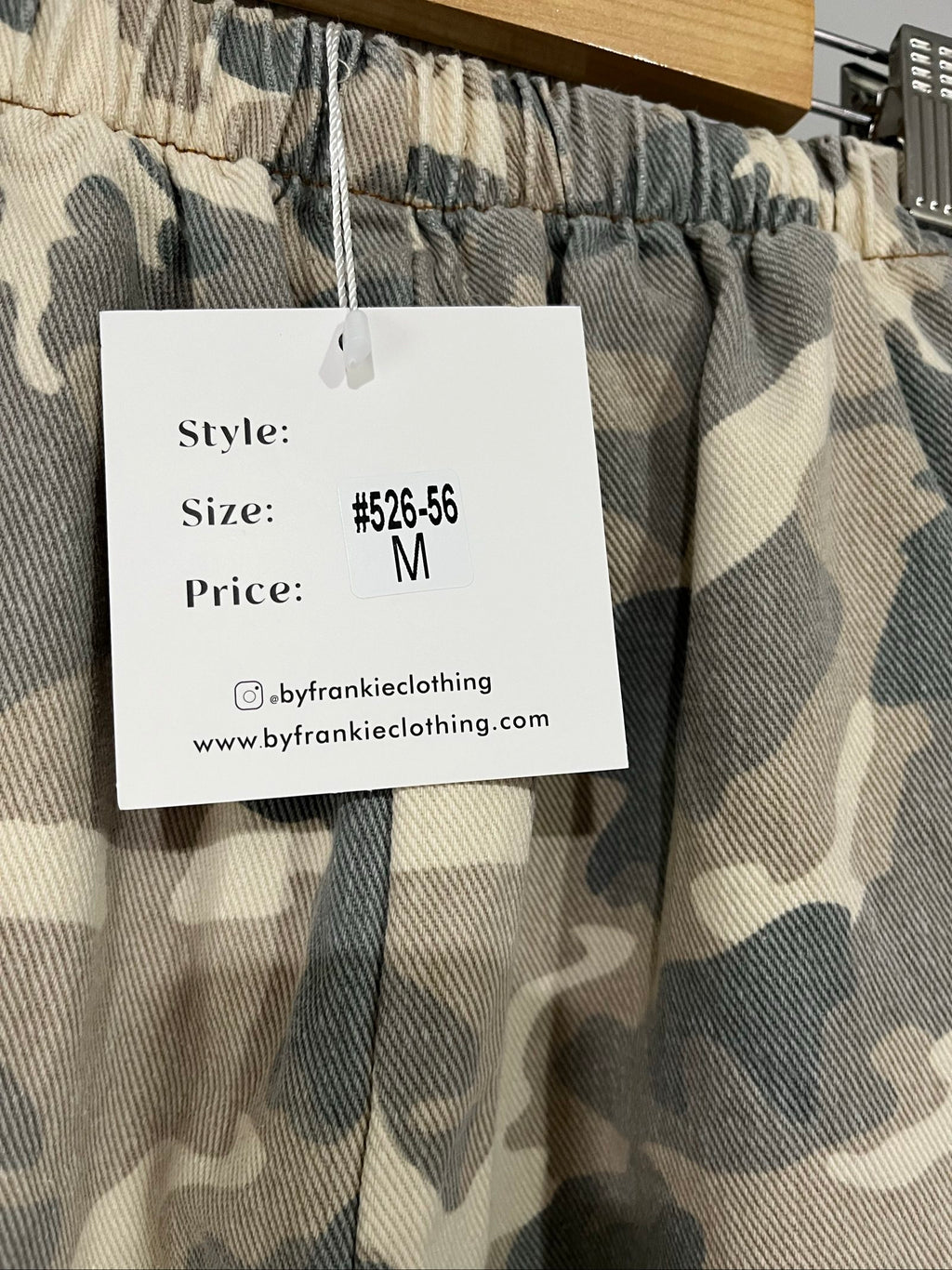 By Frankie beige and grey camo print wide-leg trousers with brown side stripes.