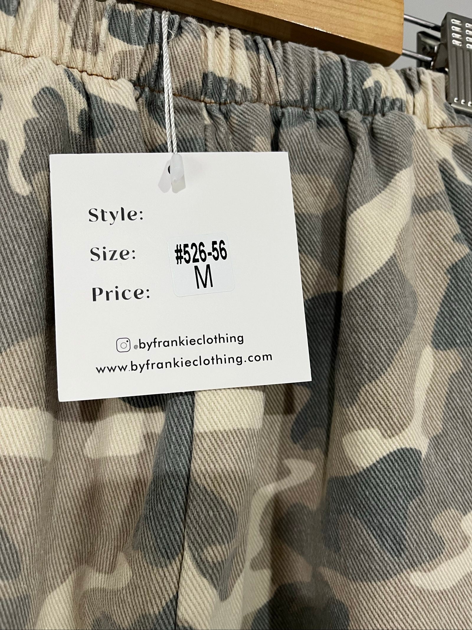 By Frankie beige and grey camo print wide-leg trousers with brown side stripes.