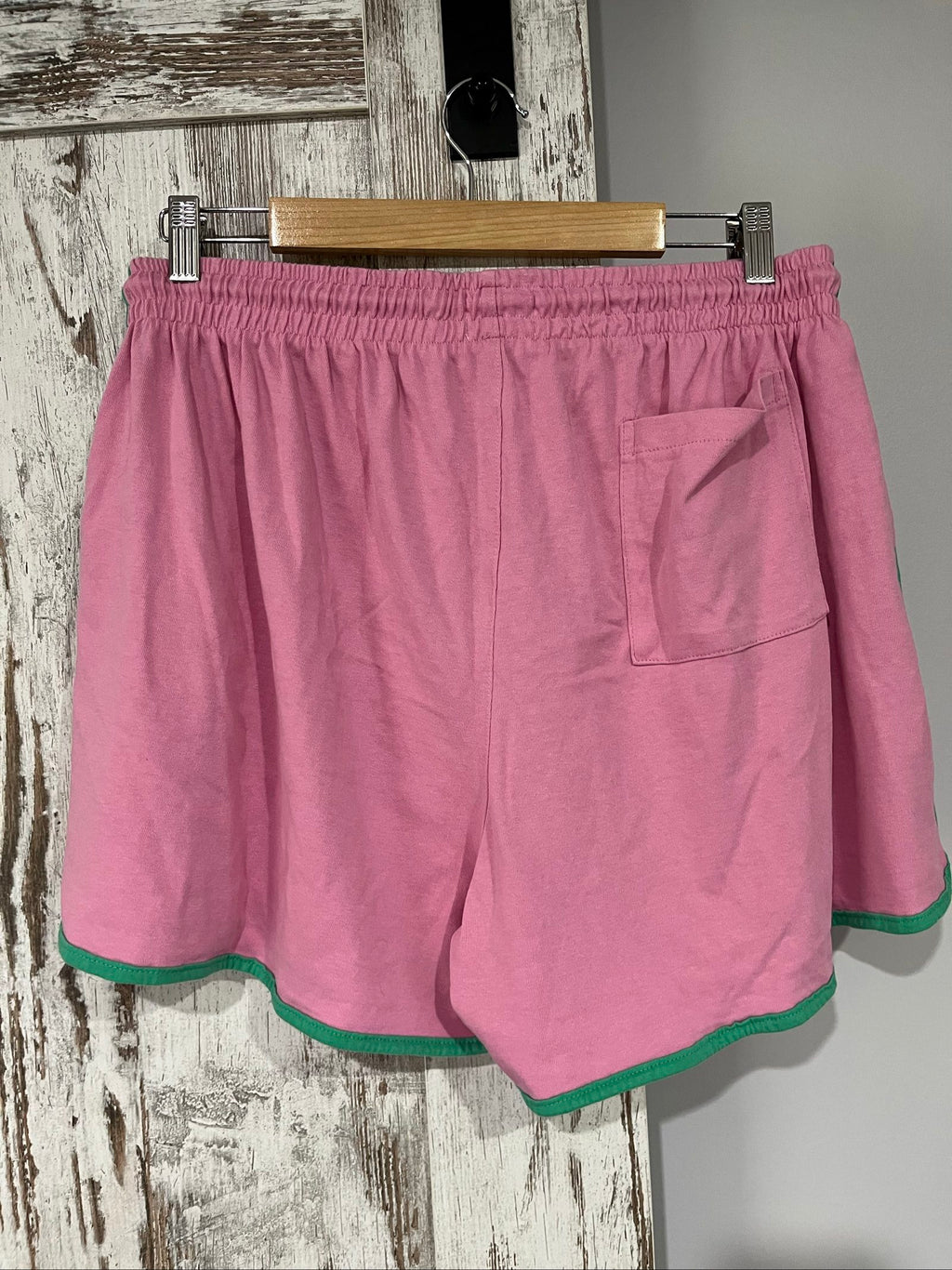 SABBI pink and green floral print casual shorts with elastic drawstring waistband and back pocket.