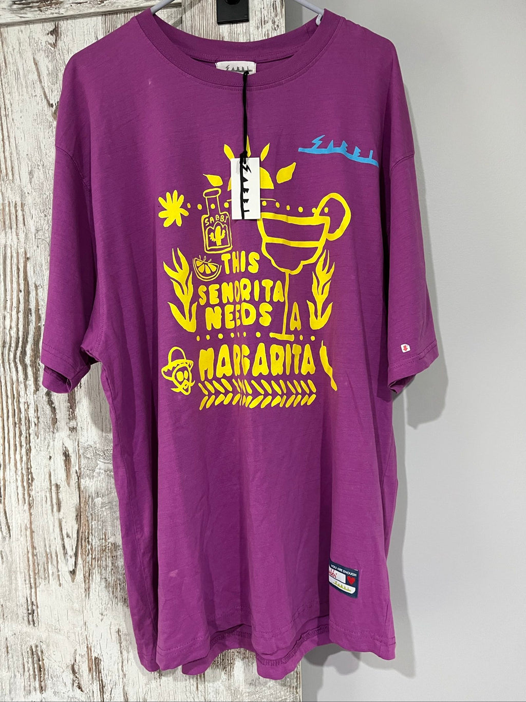 SABBI vintage graphic t-shirt purple with bold yellow front and multicoloured back print.