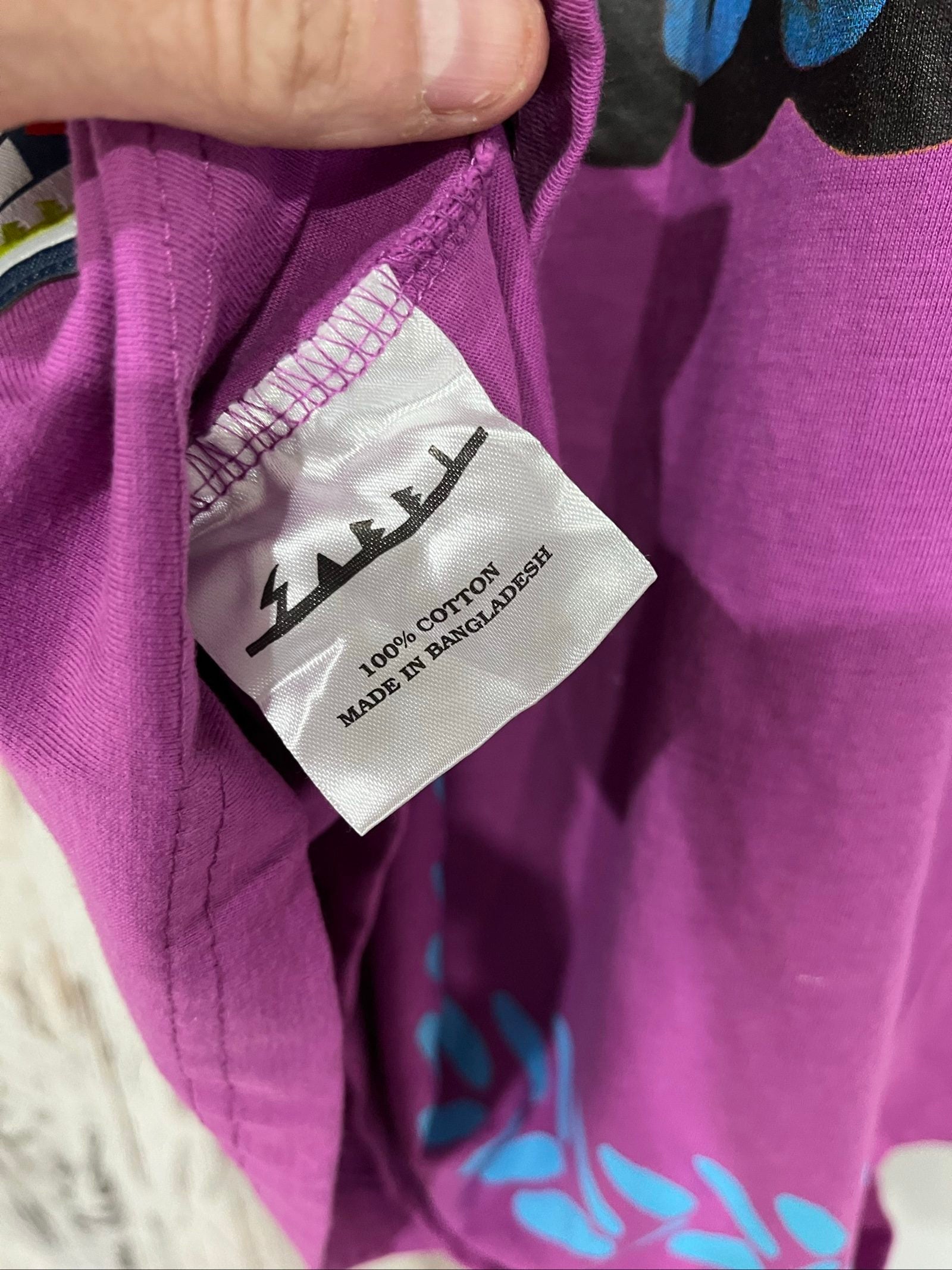 SABBI vintage graphic t-shirt purple with bold yellow front and multicoloured back print.