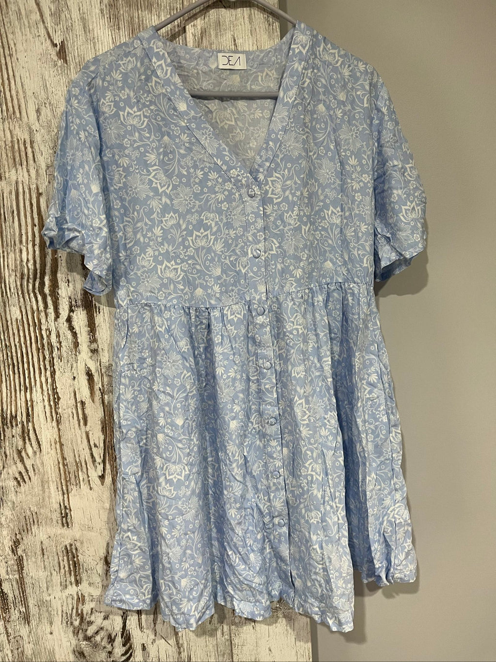DEA blue and white floral button-up dress with fabric-covered buttons and gathered waist seam.