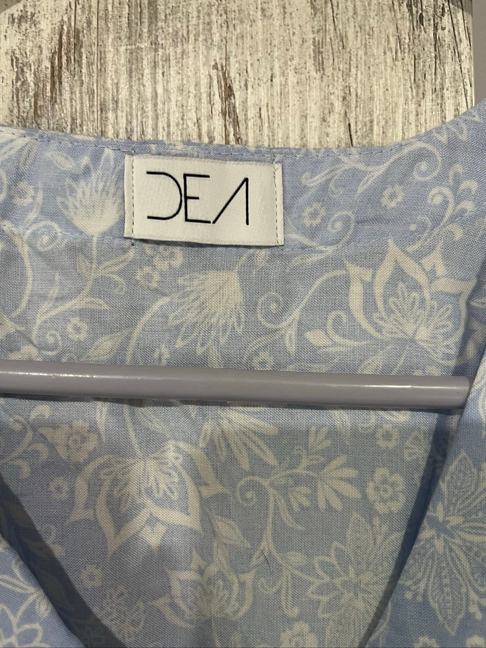 DEA blue and white floral button-up dress with fabric-covered buttons and gathered waist seam.