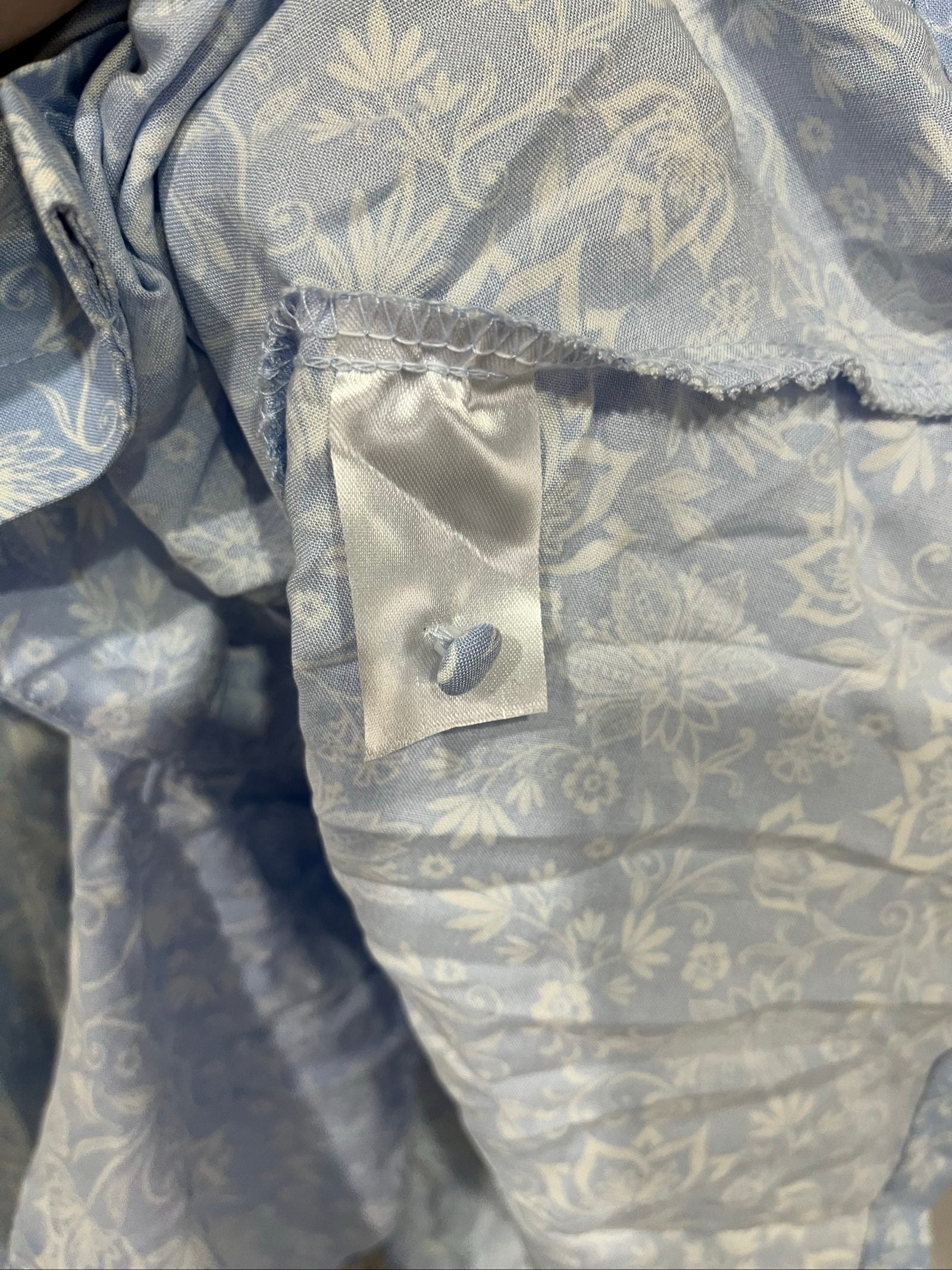 DEA blue and white floral button-up dress with fabric-covered buttons and gathered waist seam.