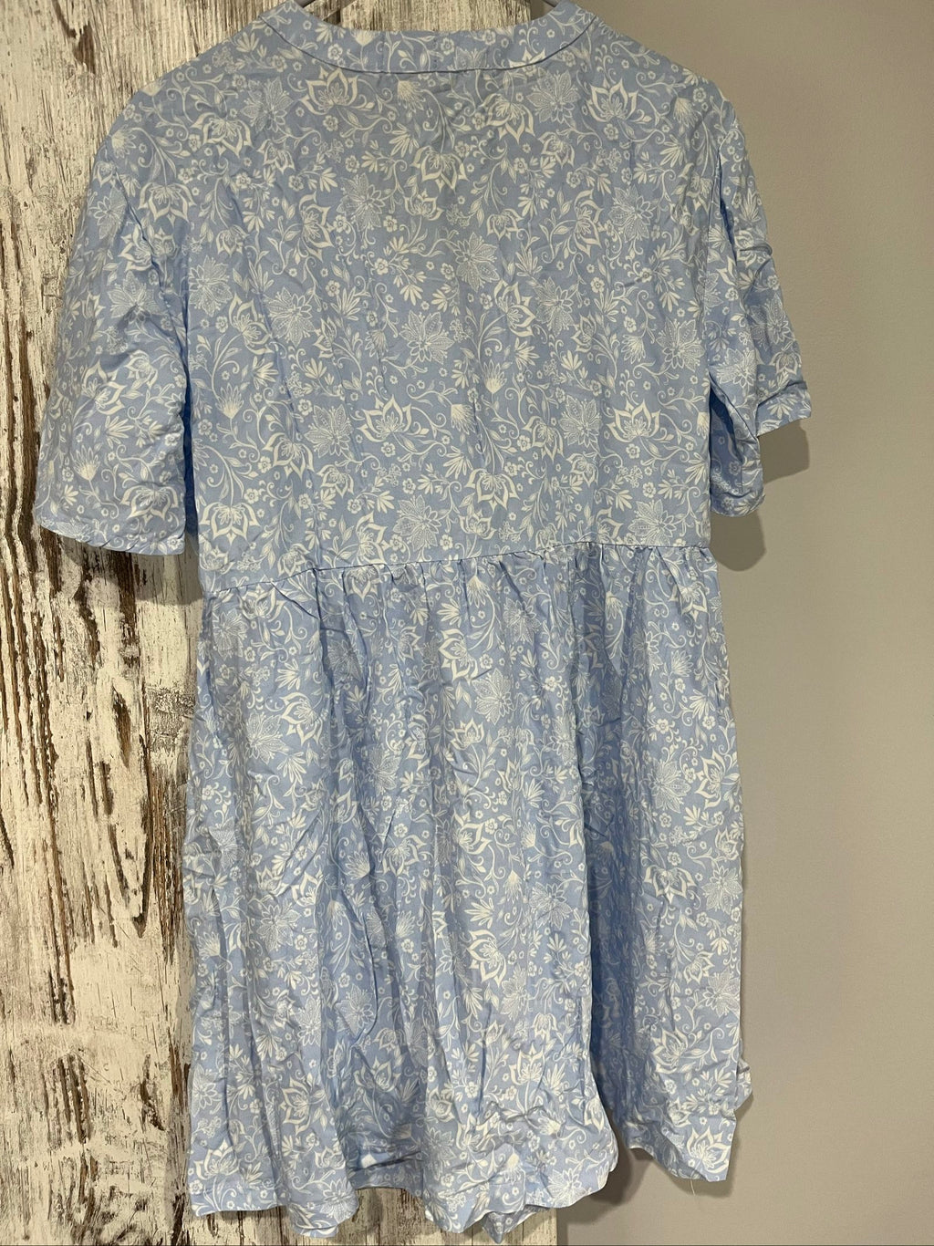 DEA blue and white floral button-up dress with fabric-covered buttons and gathered waist seam.