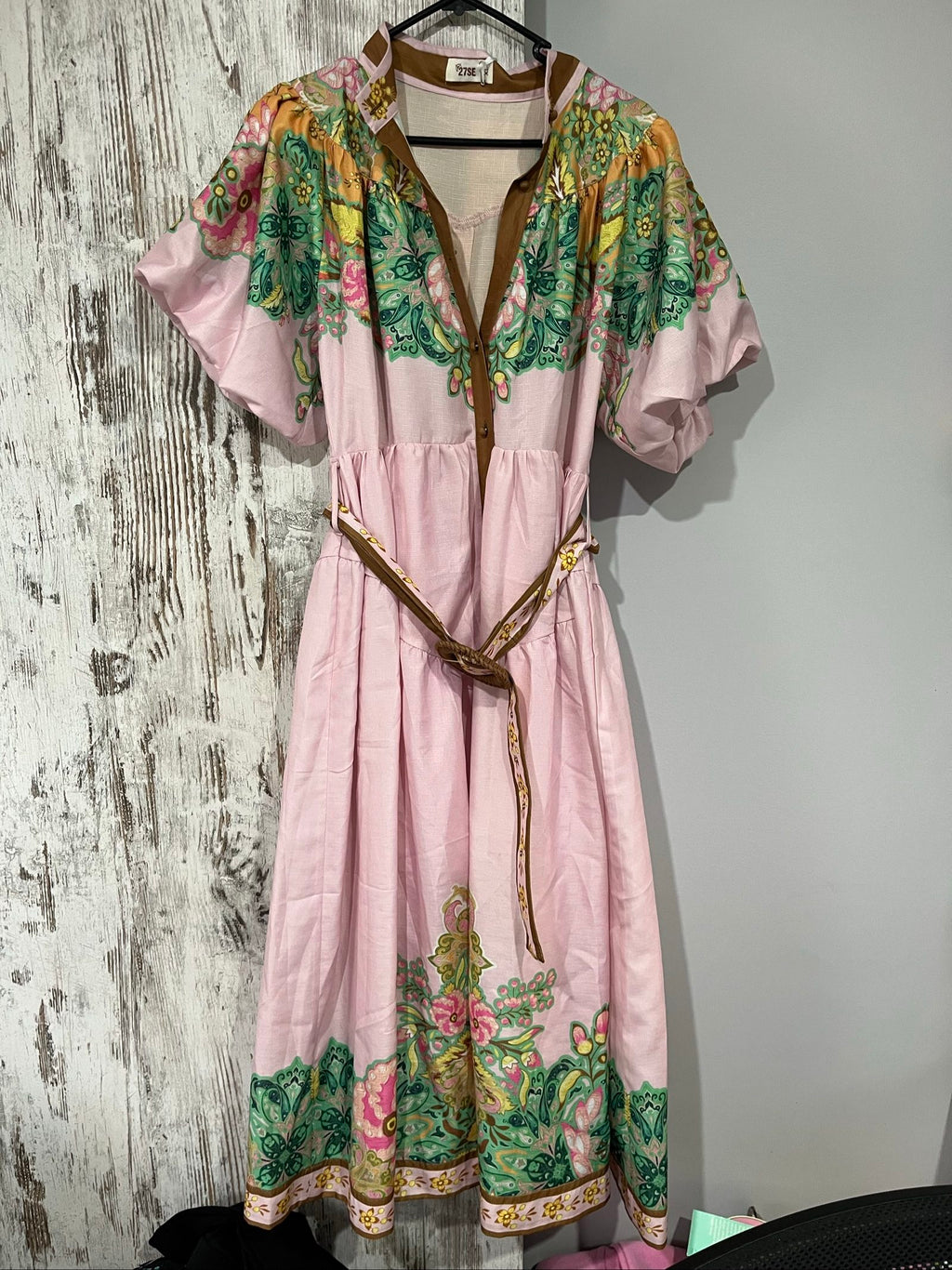 27SE brown midi dress with pink and green floral print, short puff sleeves, matching belt.