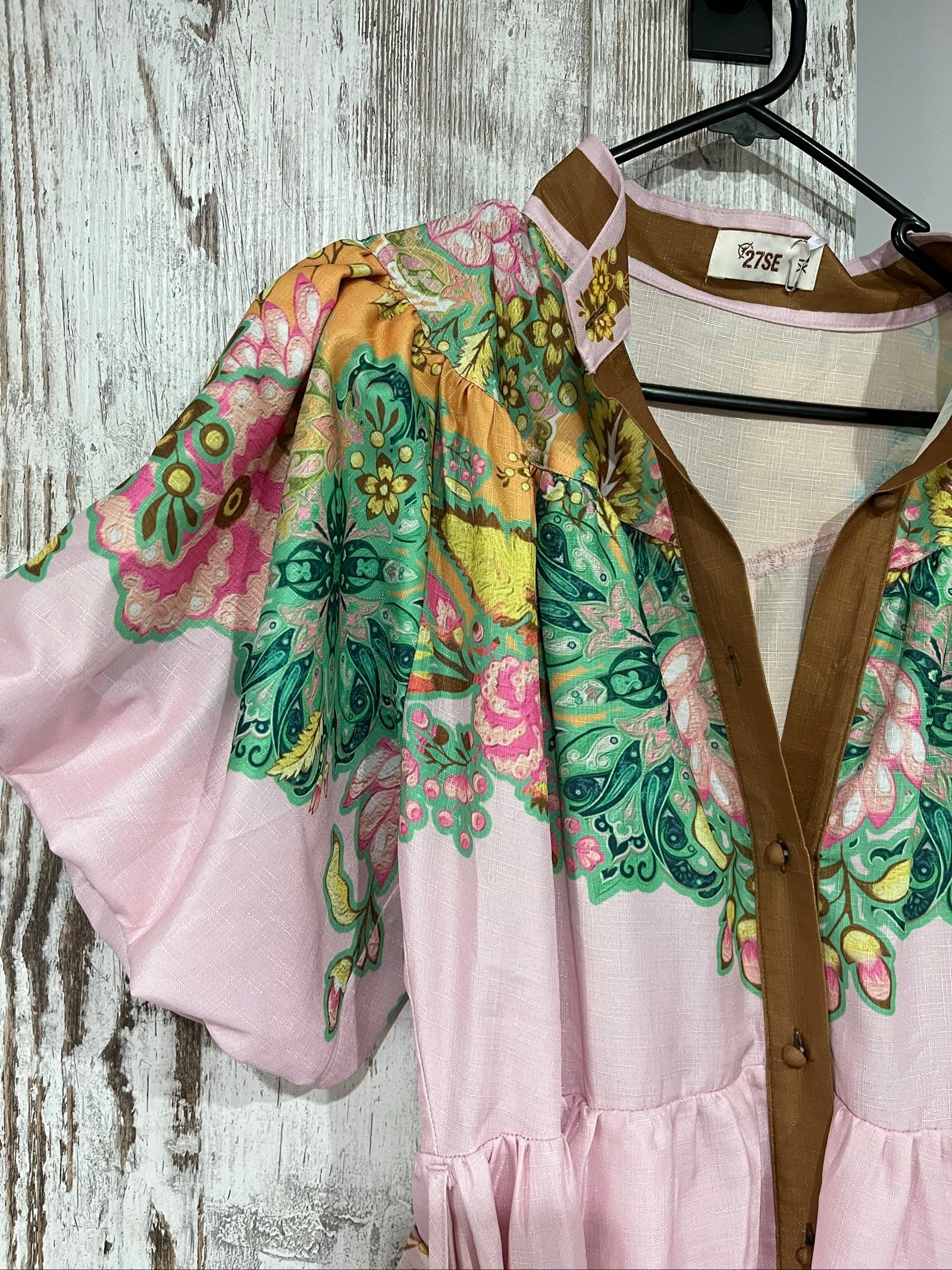 27SE brown midi dress with pink and green floral print, short puff sleeves, matching belt.