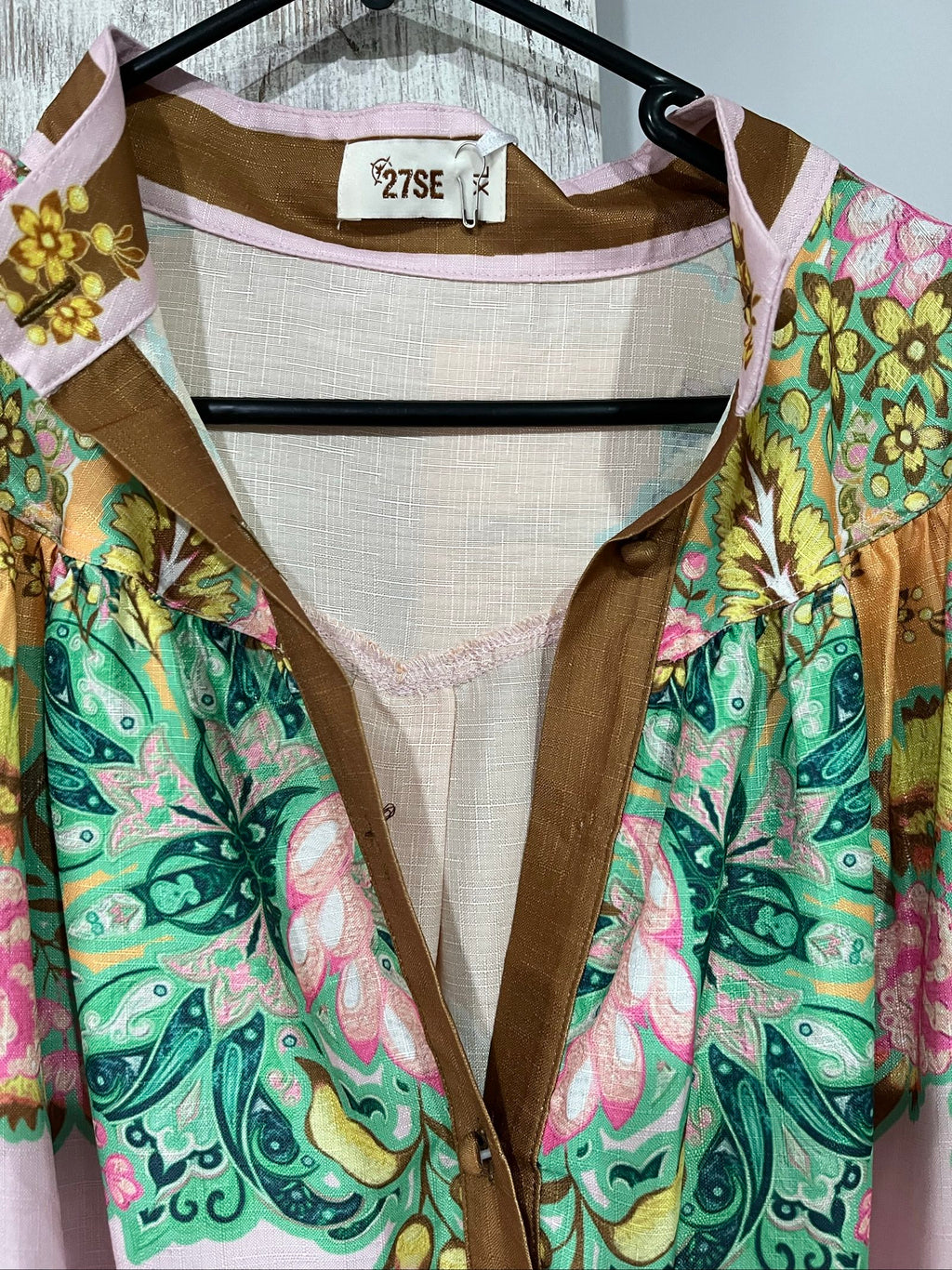 27SE brown midi dress with pink and green floral print, short puff sleeves, matching belt.