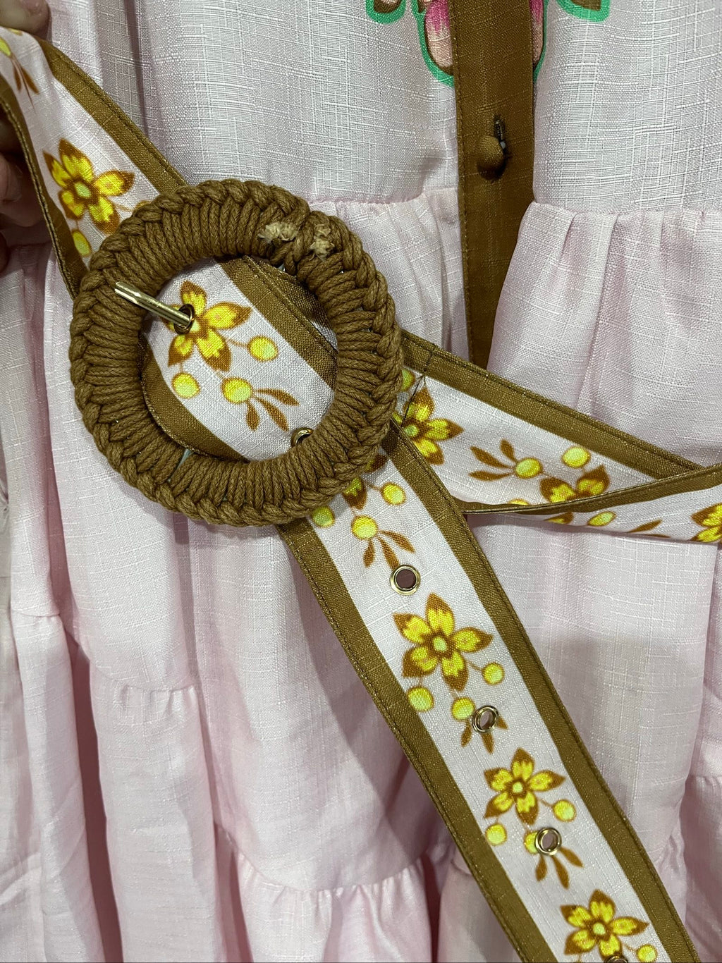 27SE brown midi dress with pink and green floral print, short puff sleeves, matching belt.