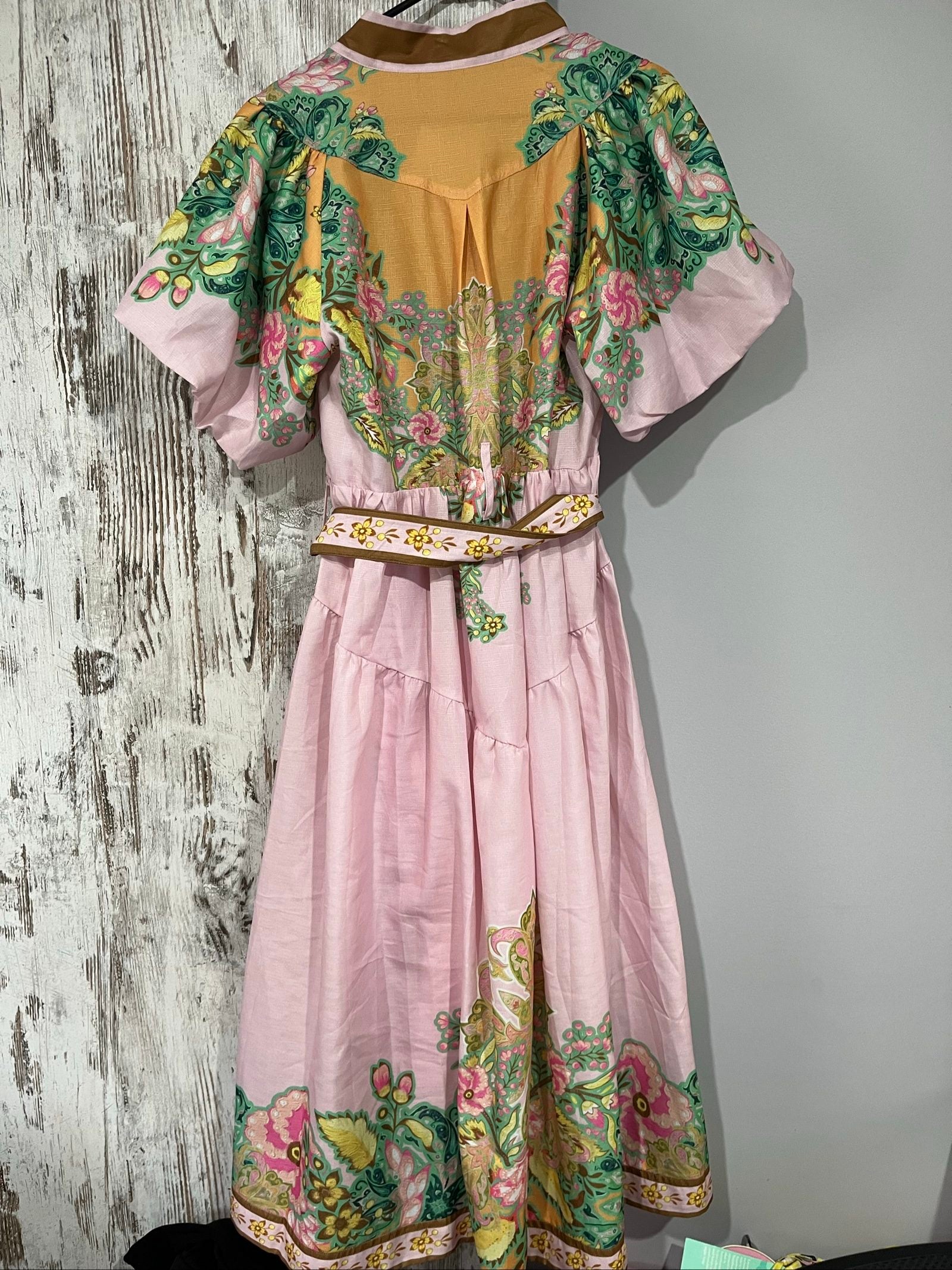 27SE brown midi dress with pink and green floral print, short puff sleeves, matching belt.