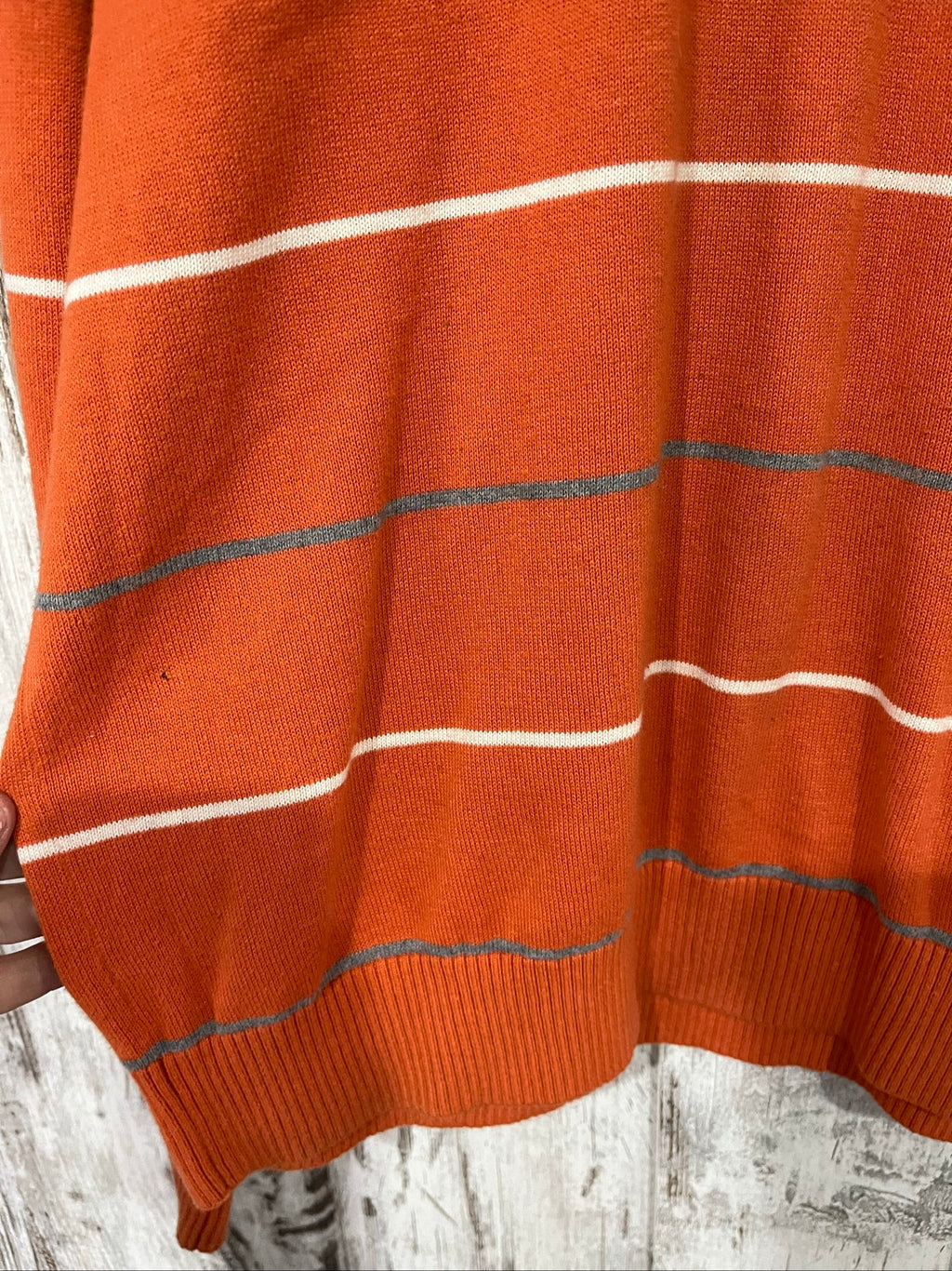 Tommy Hilfiger men's grey and white striped v-neck sweater with embroidered flag logo.