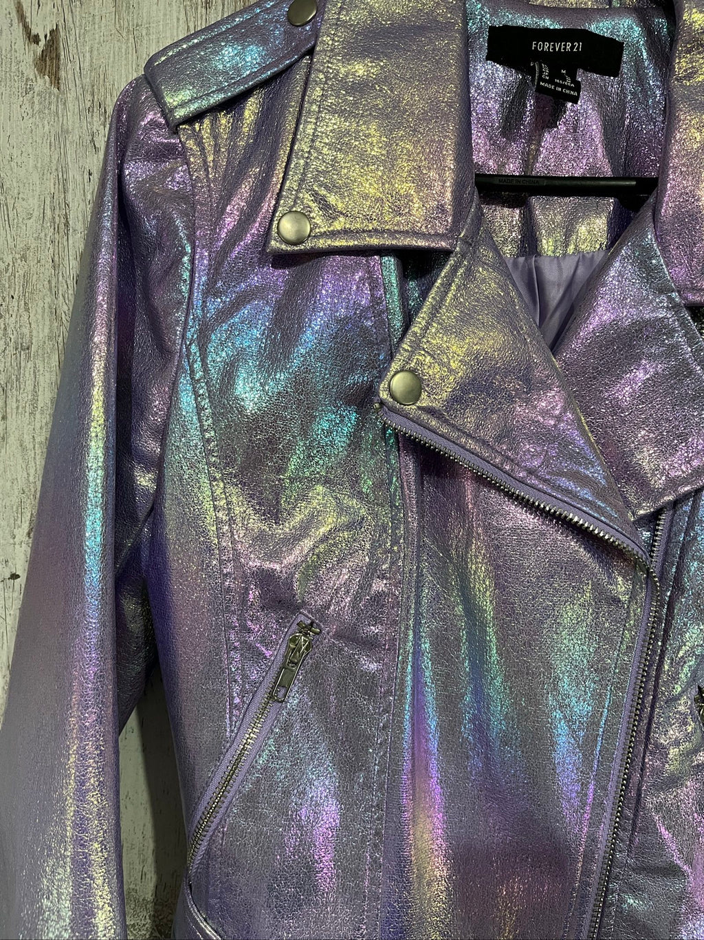 Forever 21 purple iridescent faux leather biker jacket with belted waist and zippered pockets.