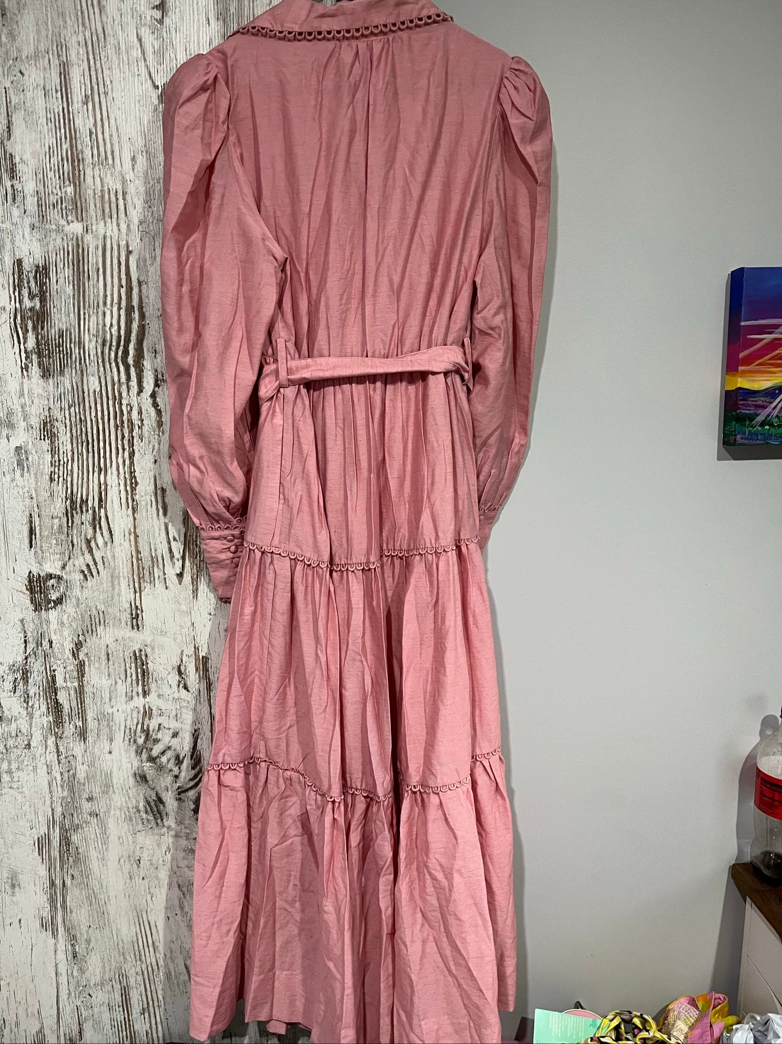 SAINT ARMONT pink midi dress with decorative trims, belted waist, and puffed sleeves.