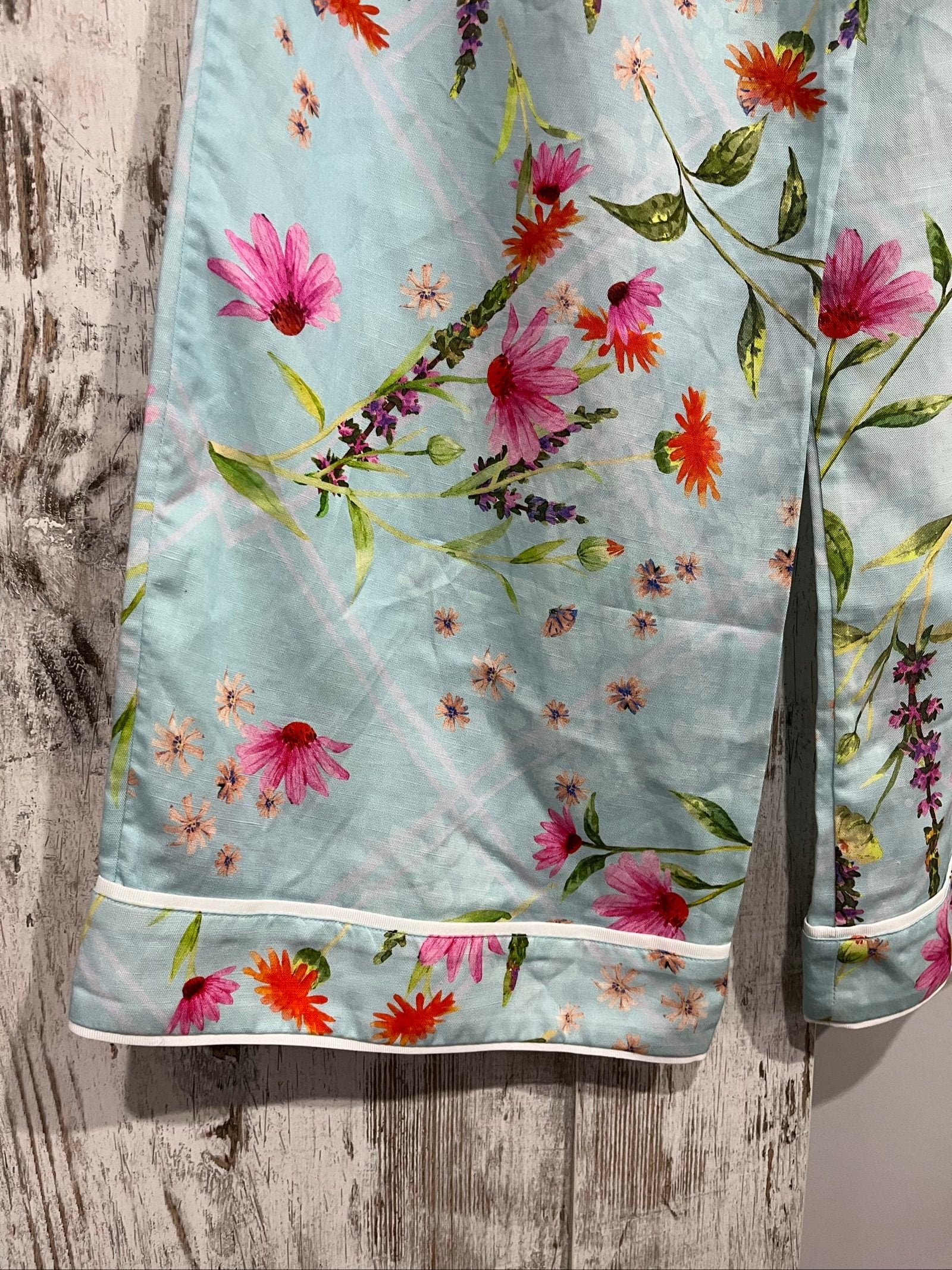 LA MAISE blue floral pants with pink and orange patterns, white trim piping detail.
