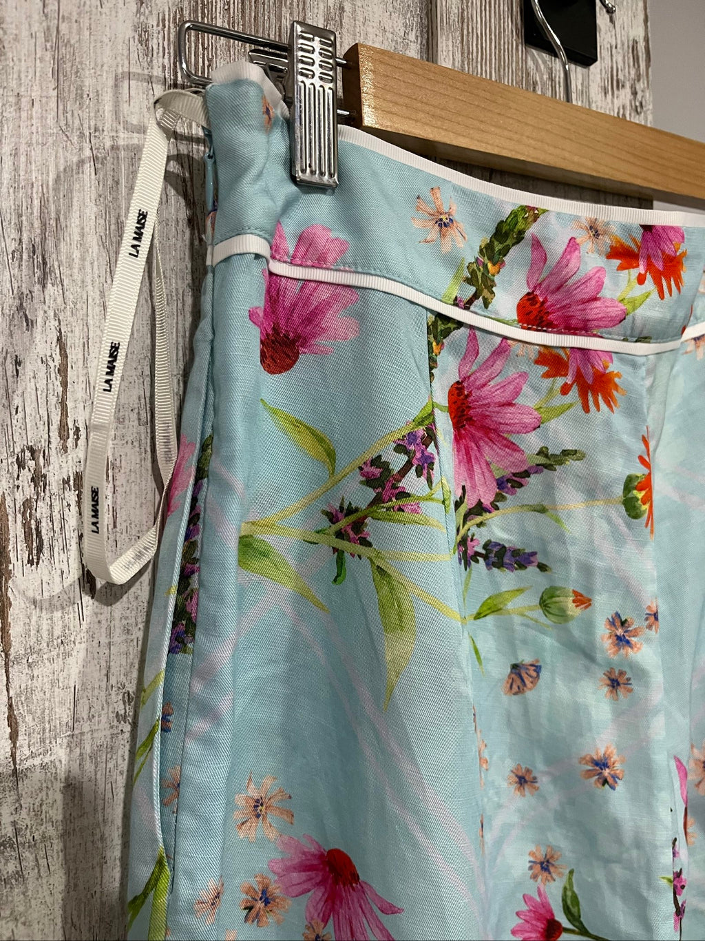 LA MAISE blue floral pants with pink and orange patterns, white trim piping detail.