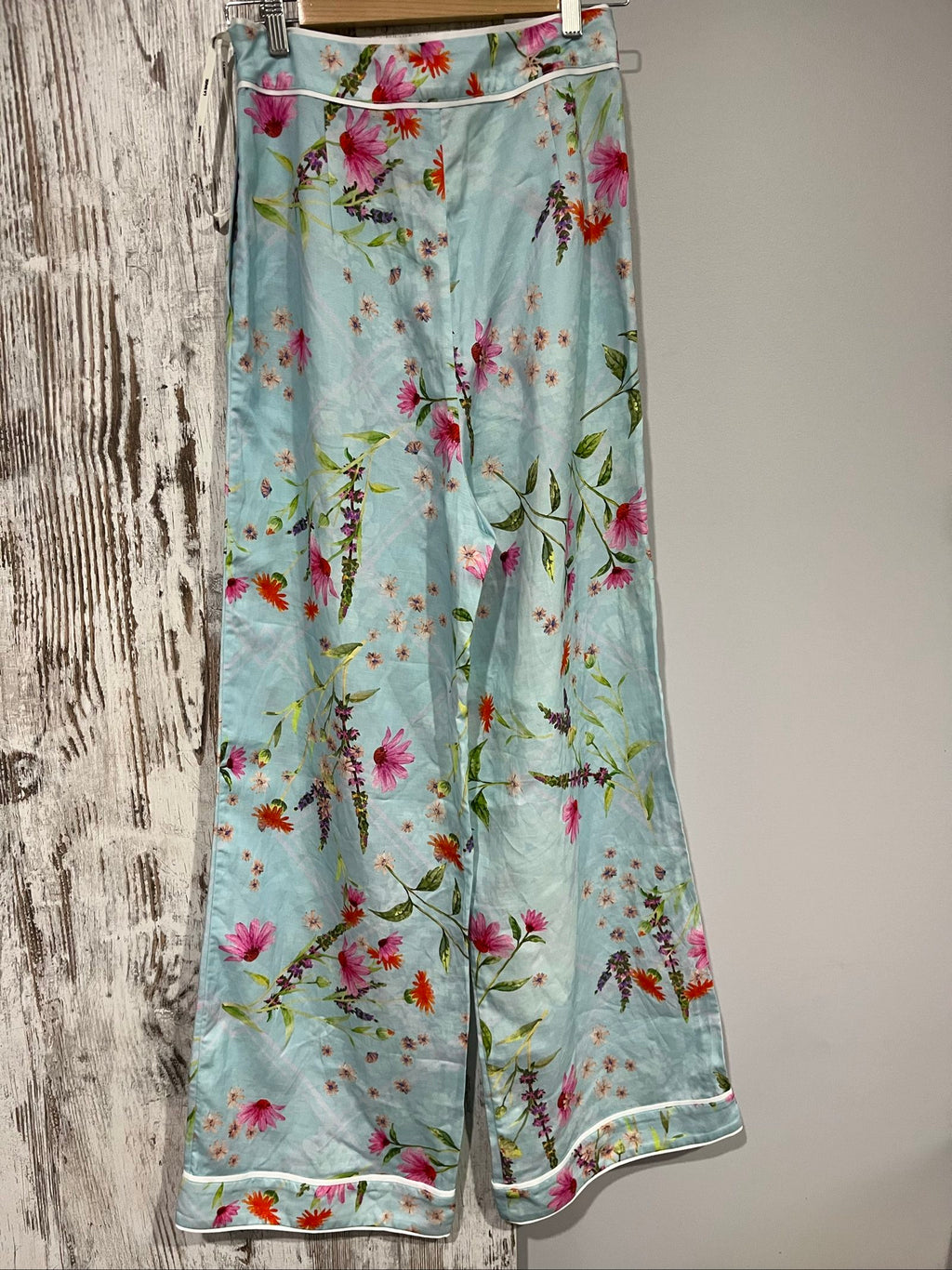 LA MAISE blue floral pants with pink and orange patterns, white trim piping details.