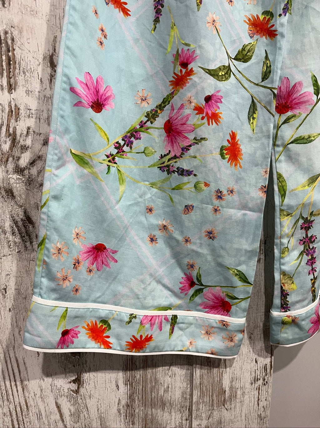 LA MAISE blue floral pants with pink and orange patterns, white trim piping details.