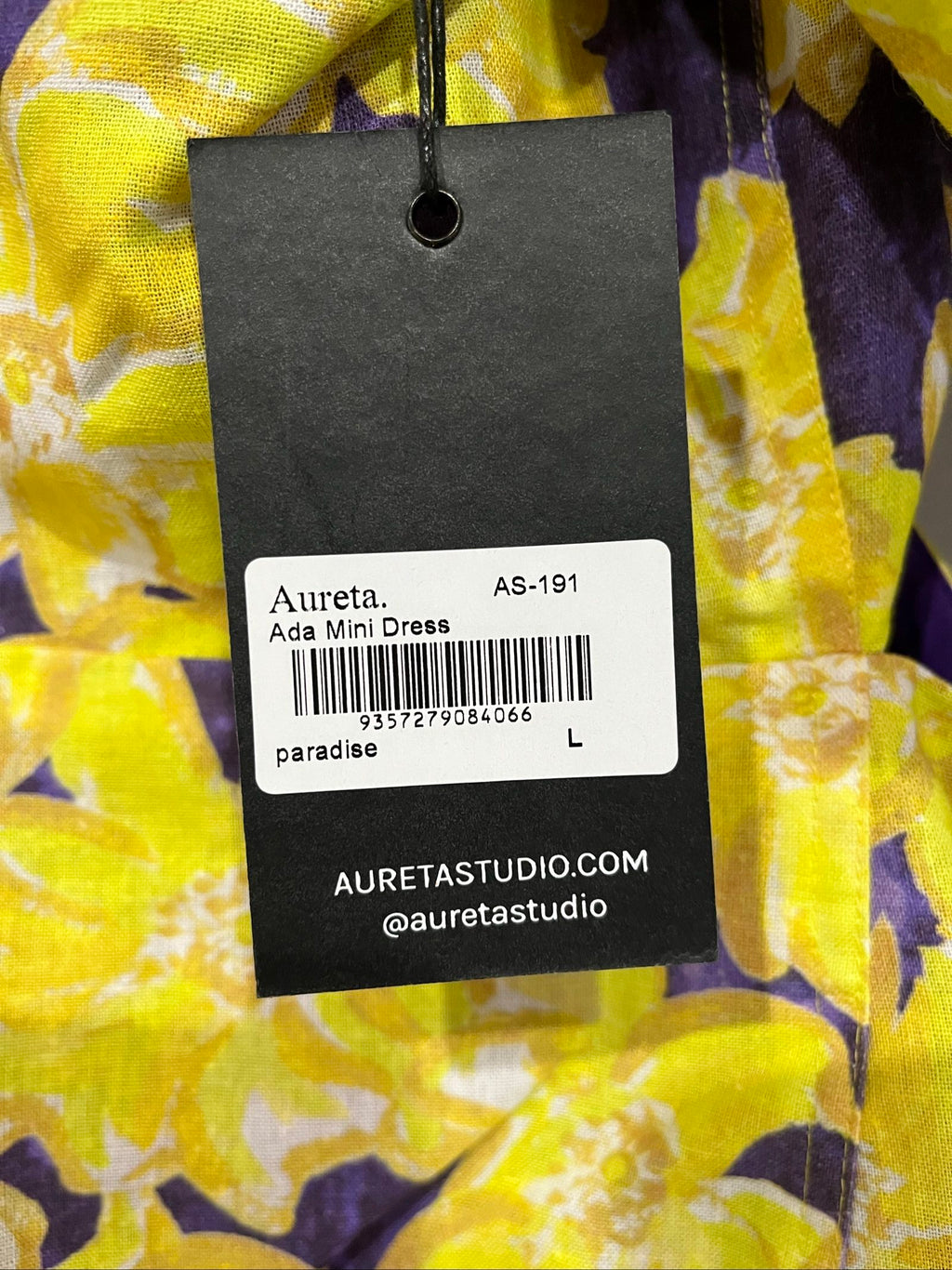 Aureta mini dress yellow and purple floral print with puff sleeves and cut-out waist.