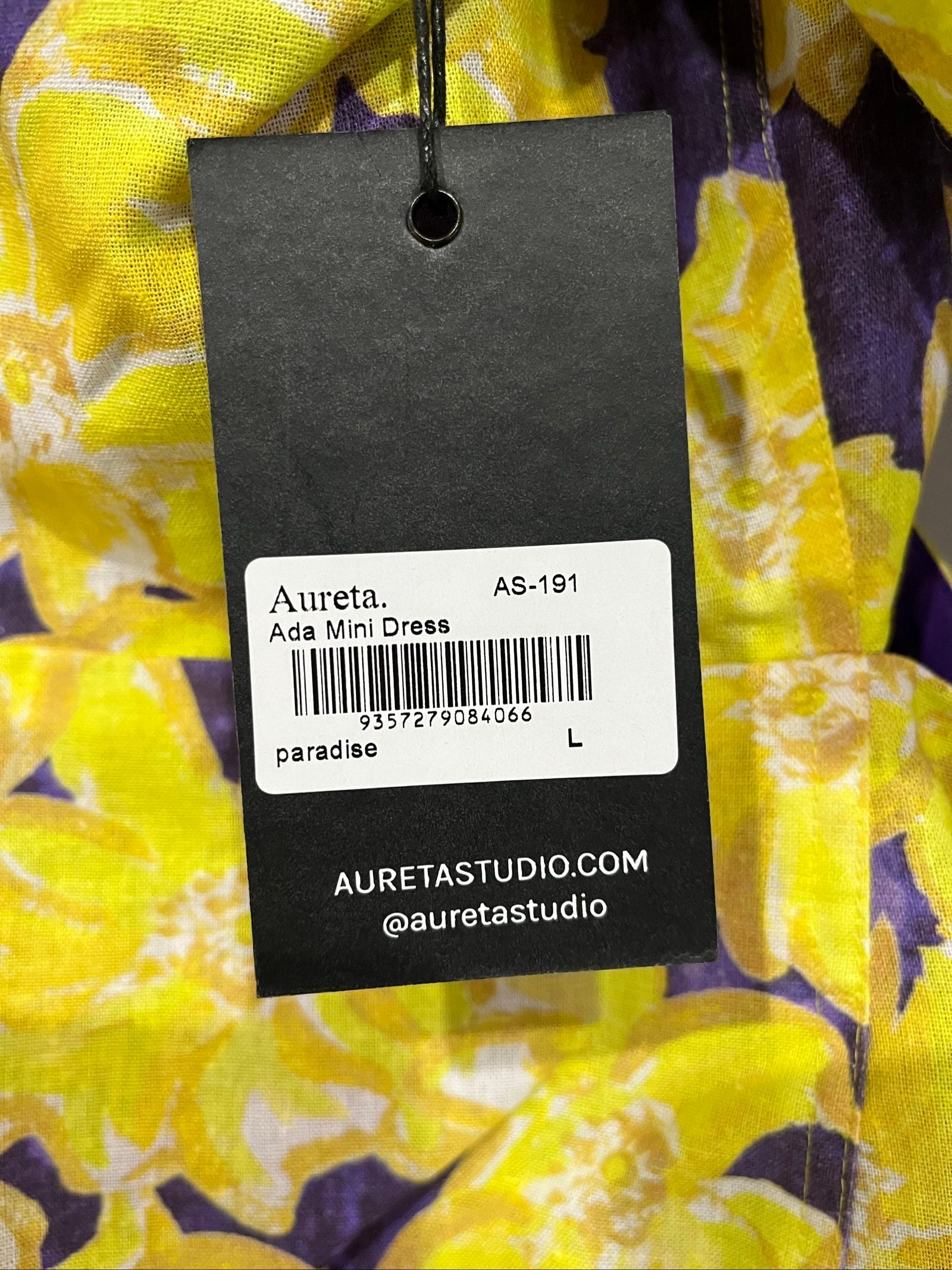 Aureta mini dress yellow and purple floral print with puff sleeves and cut-out waist.