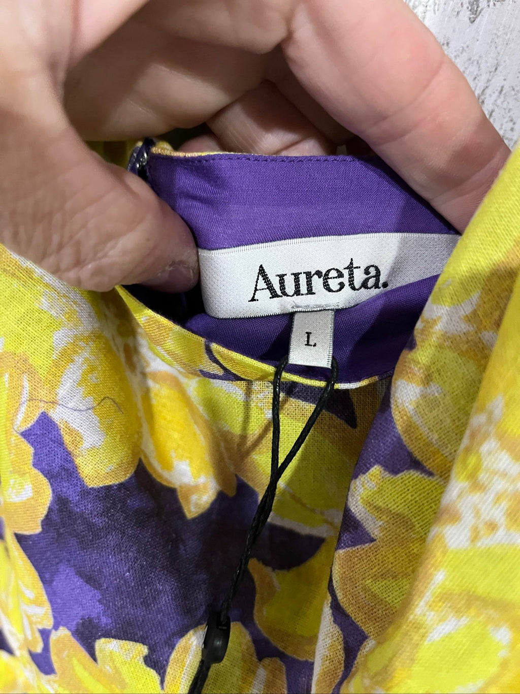 Aureta mini dress yellow and purple floral print with puff sleeves and cut-out waist.