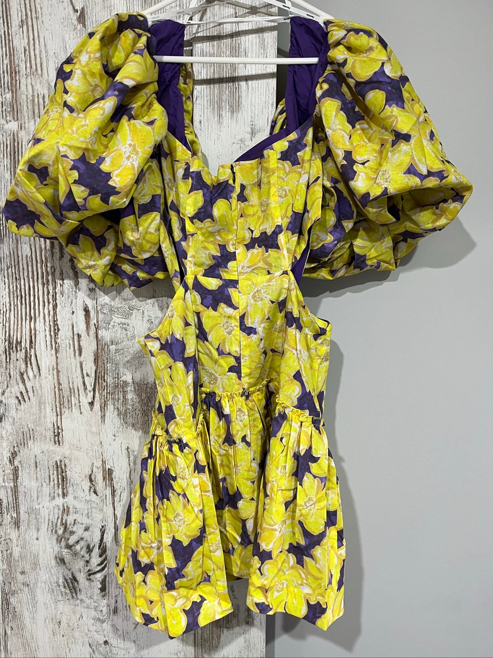 Aureta mini dress yellow and purple floral print with puff sleeves and cut-out waist.
