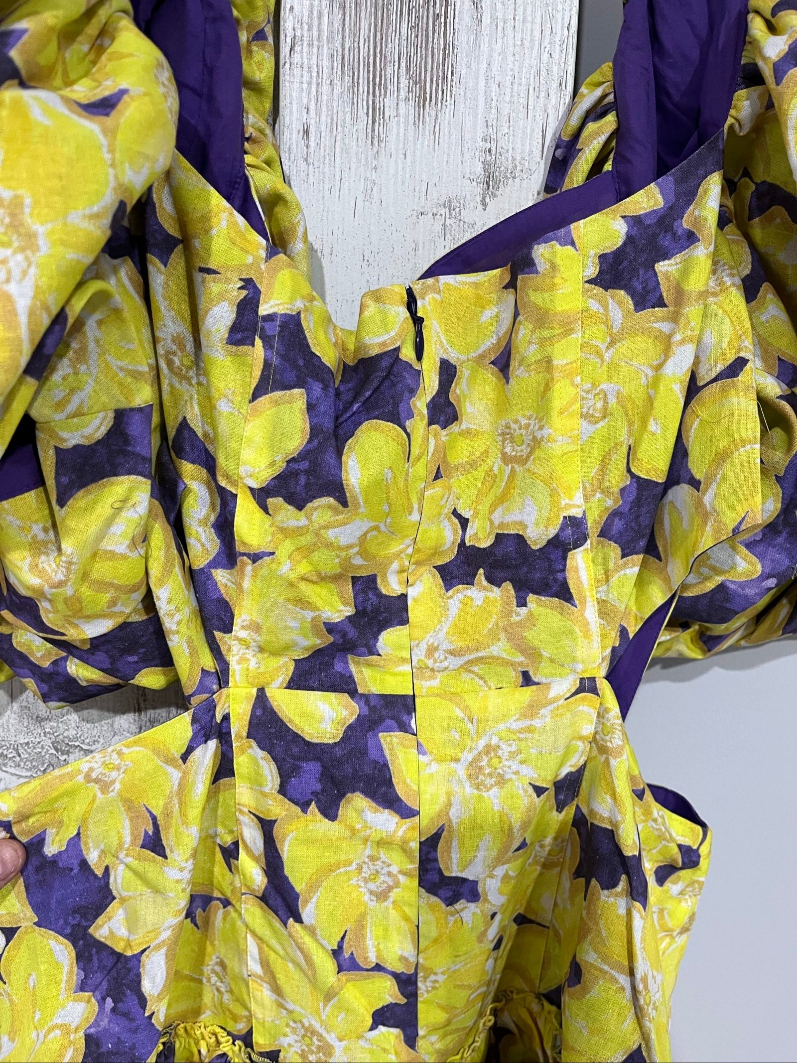 Aureta mini dress yellow and purple floral print with puff sleeves and cut-out waist.