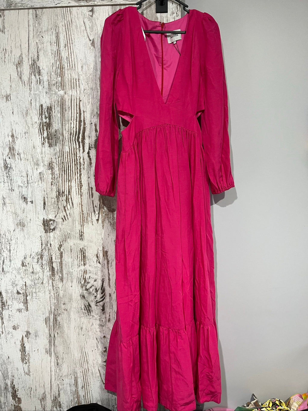 Aureta pink long sleeve maxi dress with cut-out sides and puff sleeves.