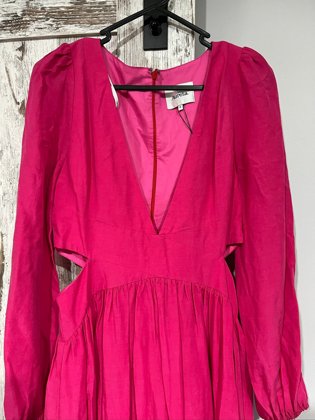 Aureta pink long sleeve maxi dress with cut-out sides and puff sleeves.