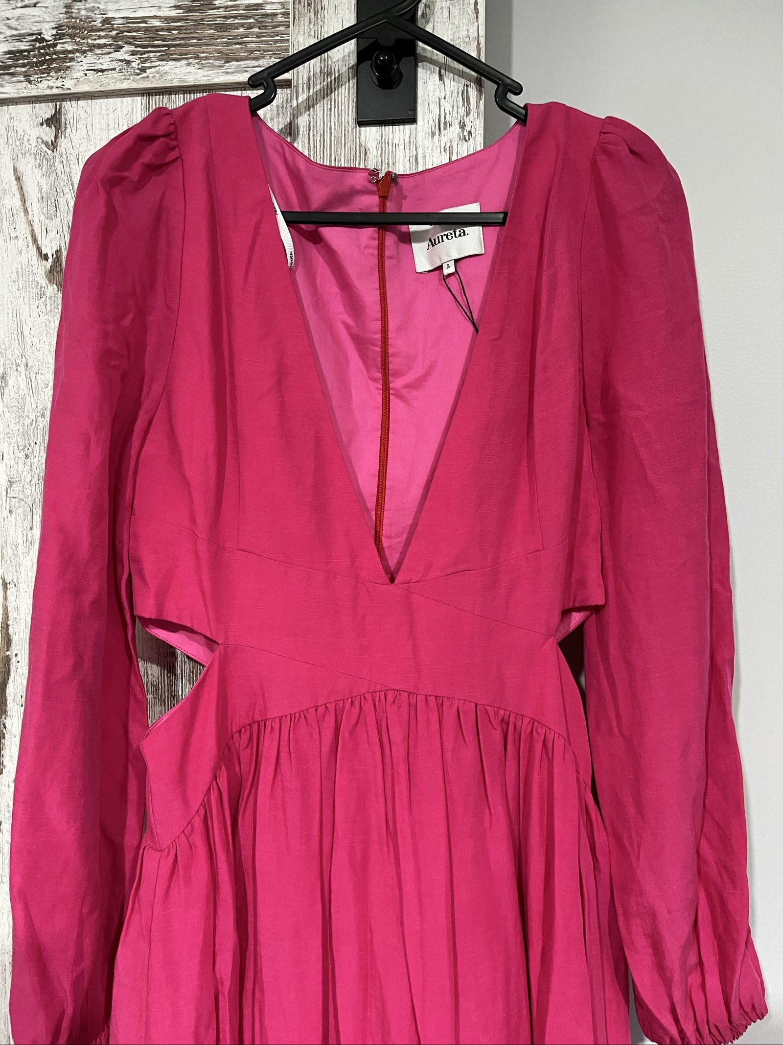Aureta pink long sleeve maxi dress with cut-out sides and puff sleeves.