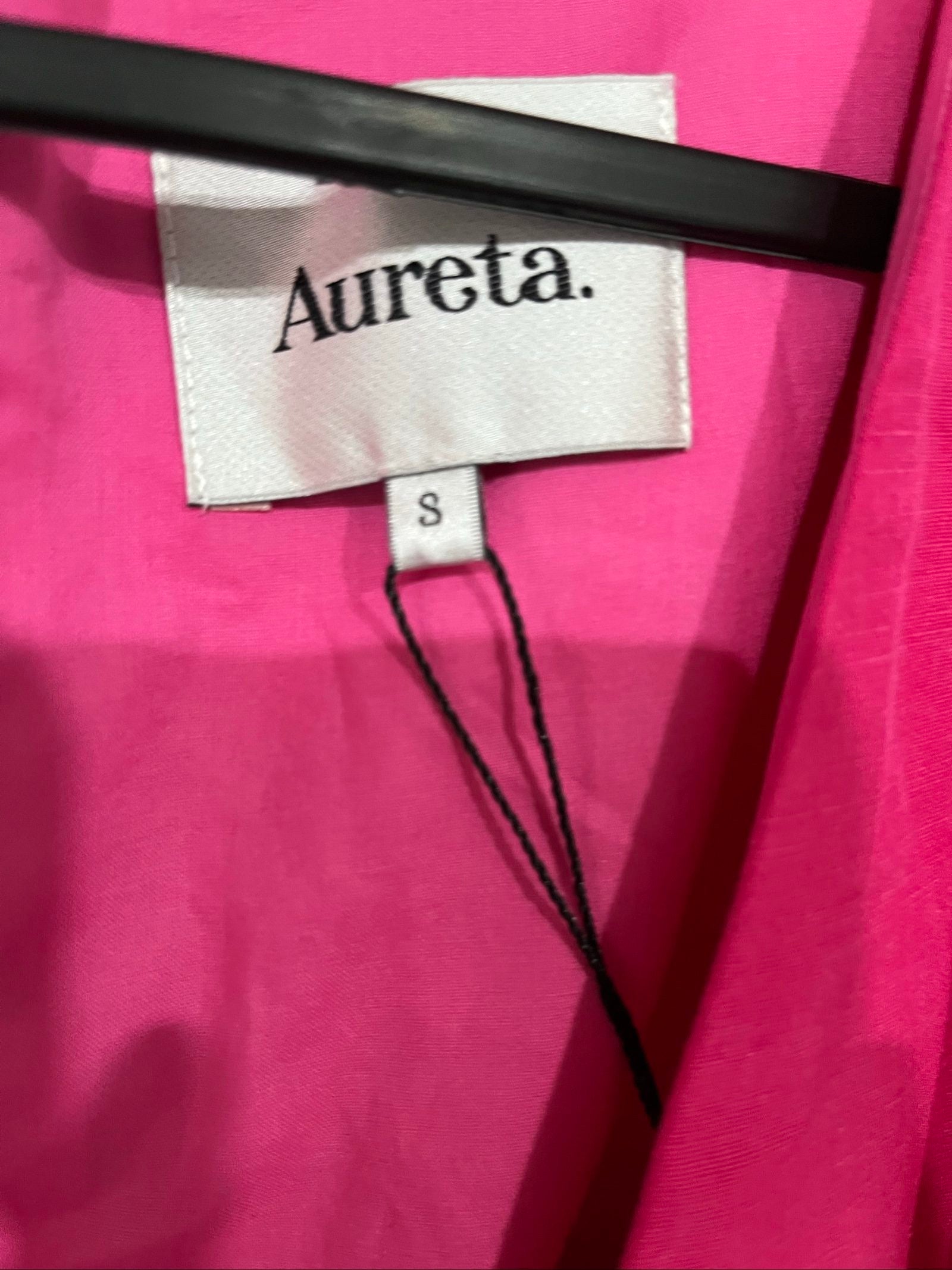 Aureta pink long sleeve maxi dress with cut-out sides and puff sleeves.