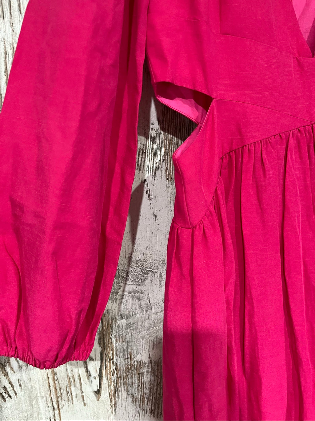 Aureta pink long sleeve maxi dress with cut-out sides and puff sleeves.