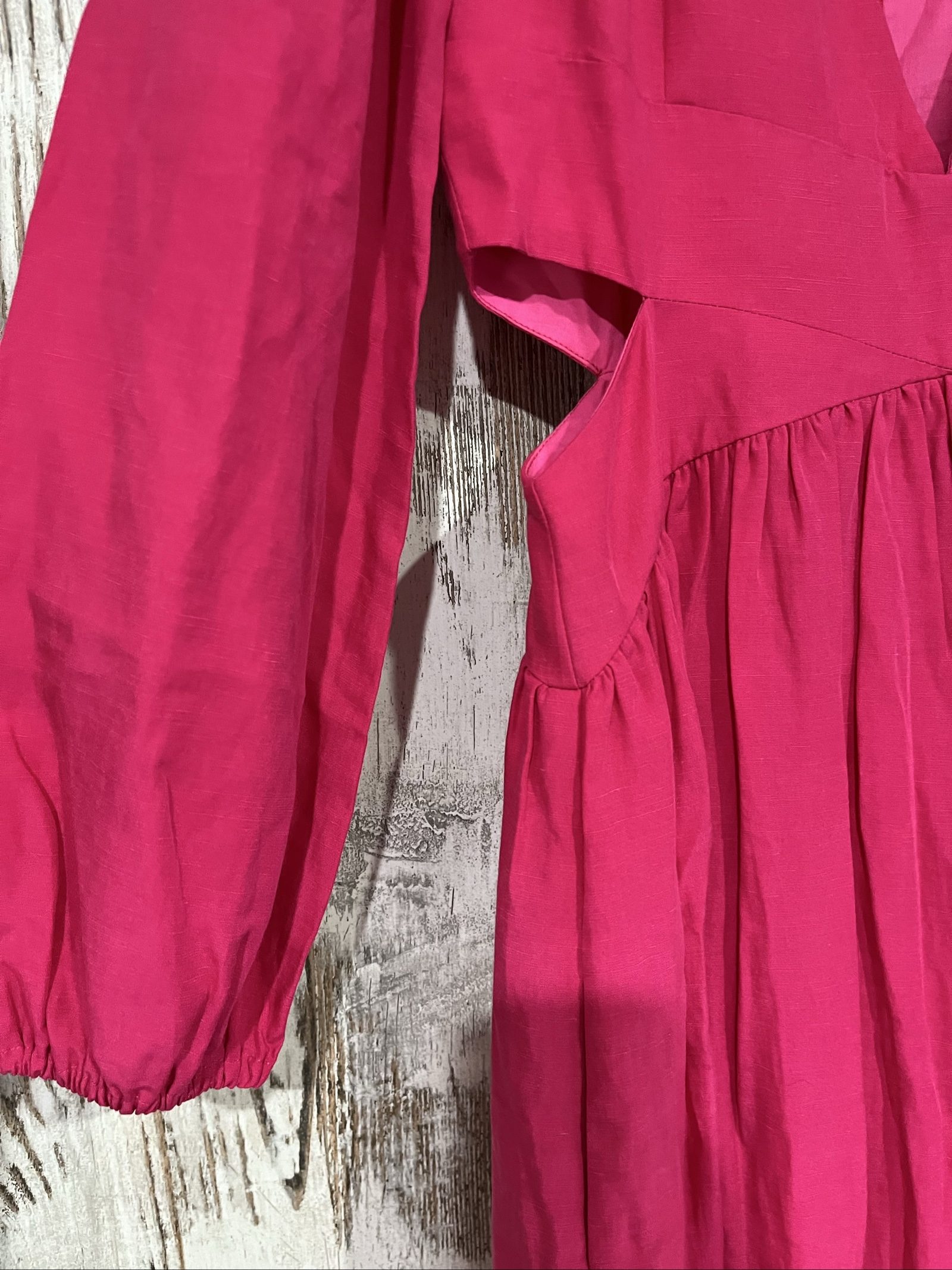 Aureta pink long sleeve maxi dress with cut-out sides and puff sleeves.
