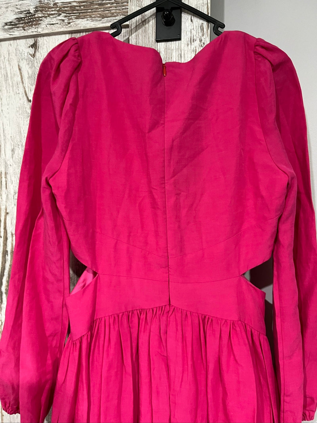 Aureta pink long sleeve maxi dress with cut-out sides and puff sleeves.