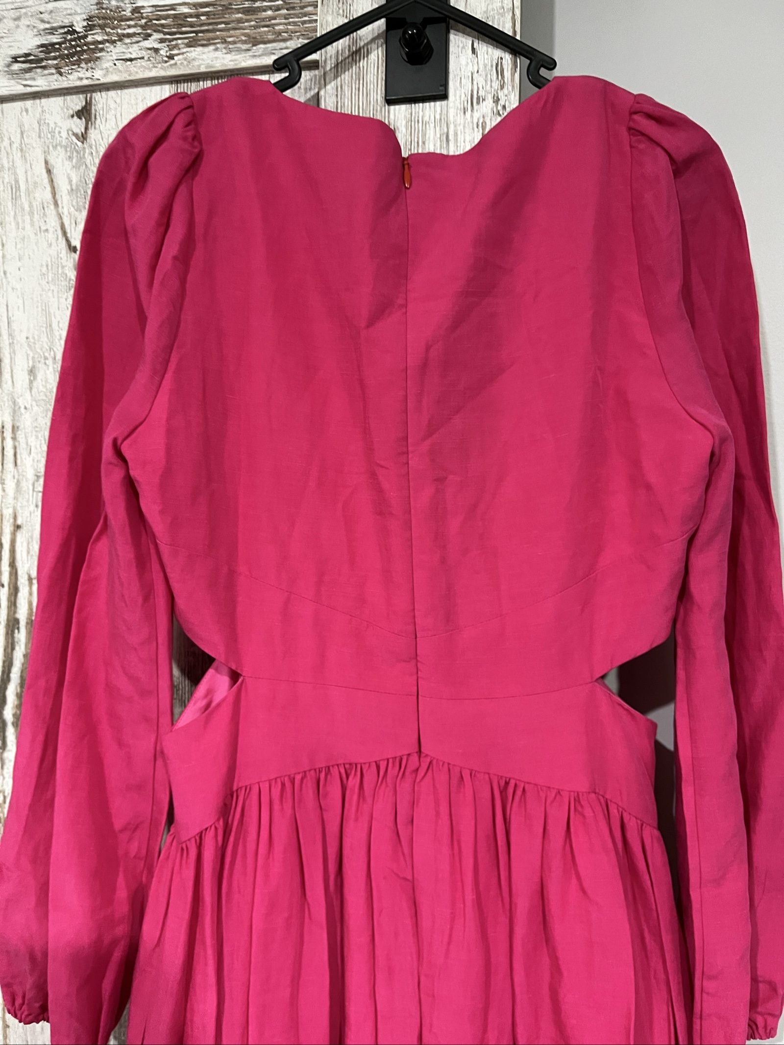 Aureta pink long sleeve maxi dress with cut-out sides and puff sleeves.