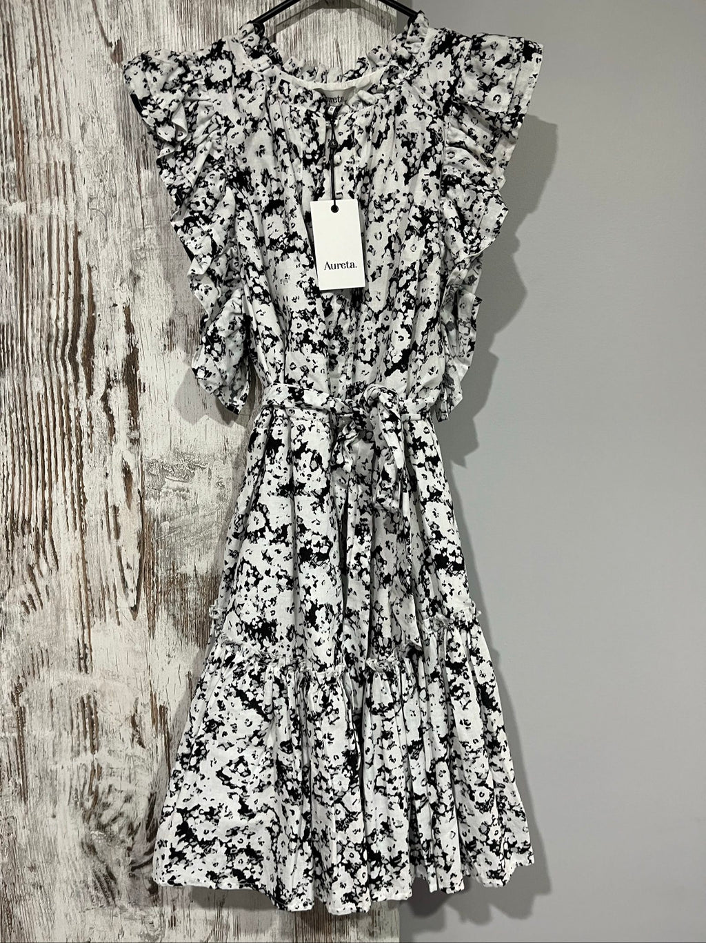 Aureta mini dress black and white abstract floral print with ruffle sleeves and buttons.