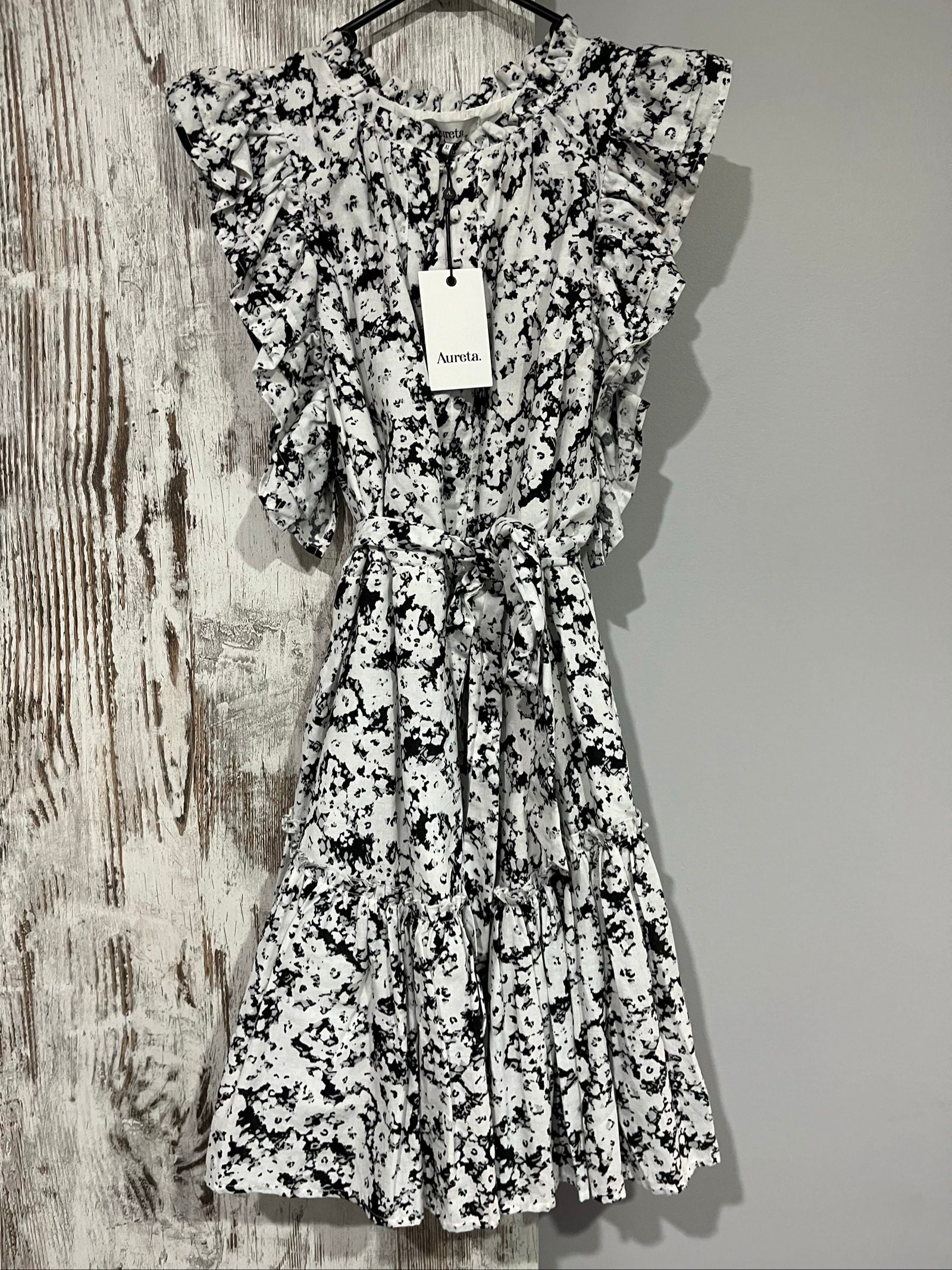 Aureta mini dress black and white abstract floral print with ruffle sleeves and buttons.
