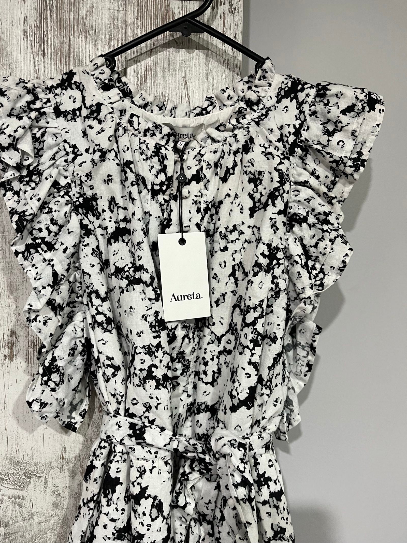 Aureta mini dress black and white abstract floral print with ruffle sleeves and buttons.