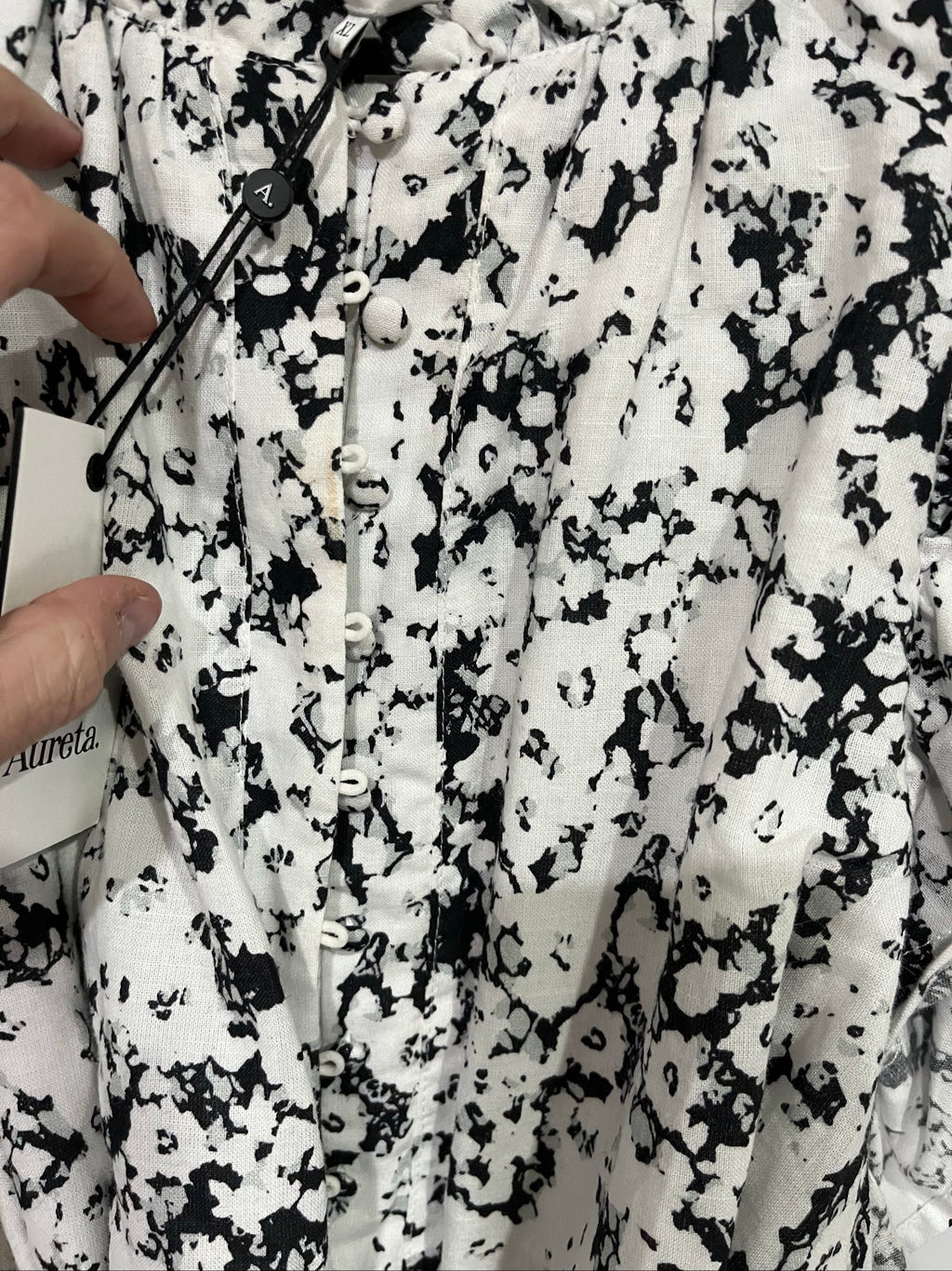 Aureta mini dress black and white abstract floral print with ruffle sleeves and buttons.