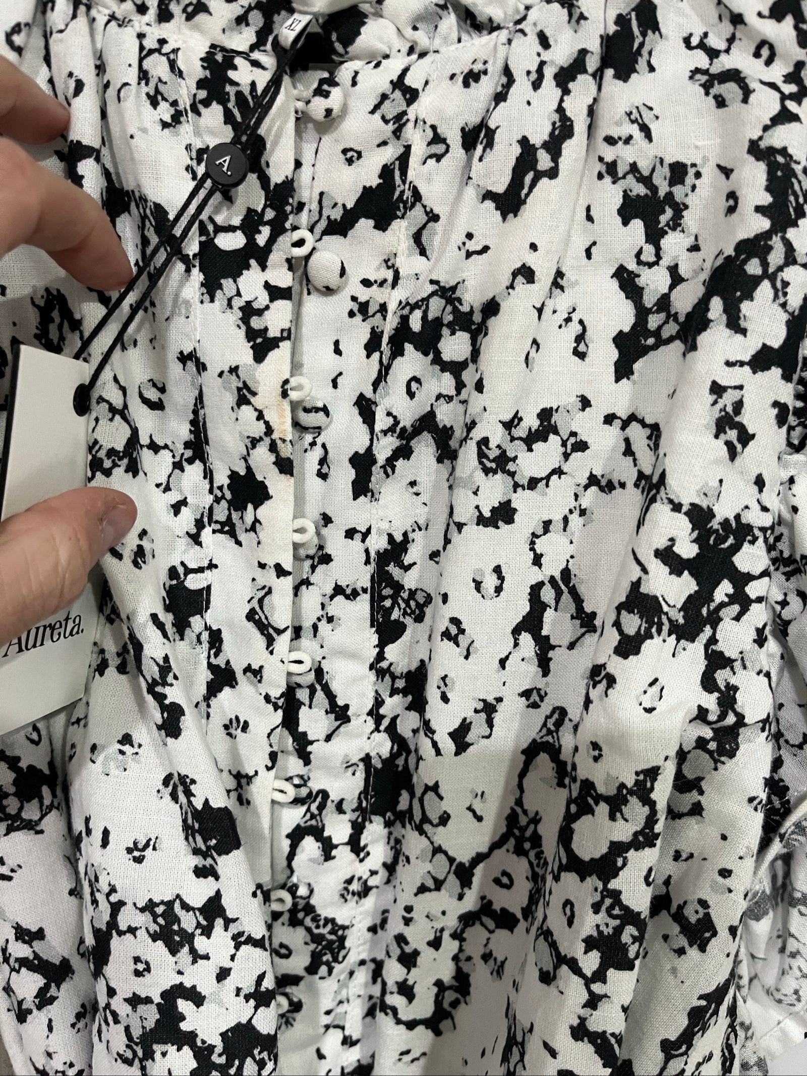 Aureta mini dress black and white abstract floral print with ruffle sleeves and buttons.