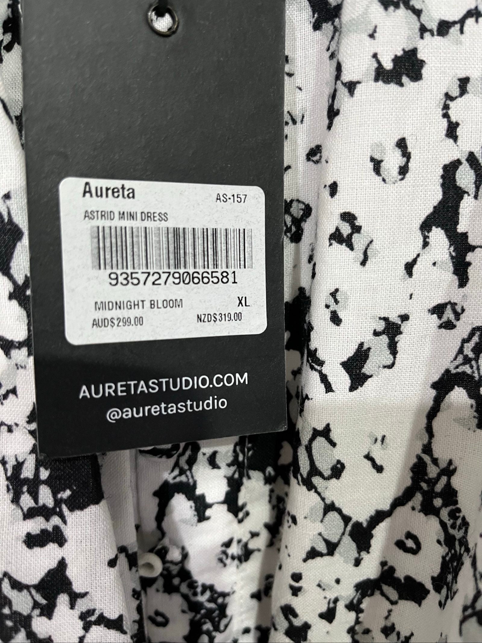 Aureta mini dress black and white abstract floral print with ruffle sleeves and buttons.
