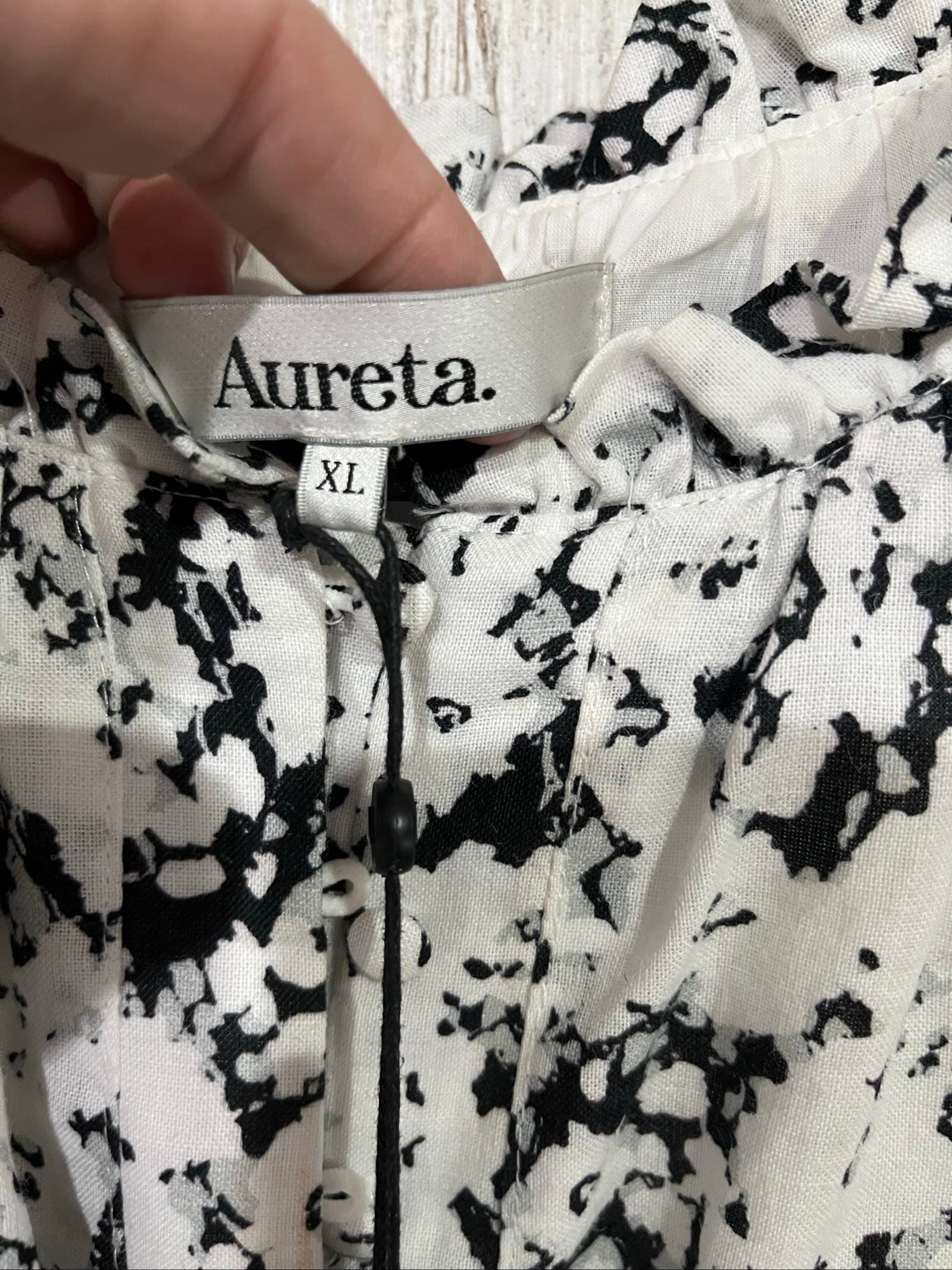 Aureta mini dress black and white abstract floral print with ruffle sleeves and buttons.